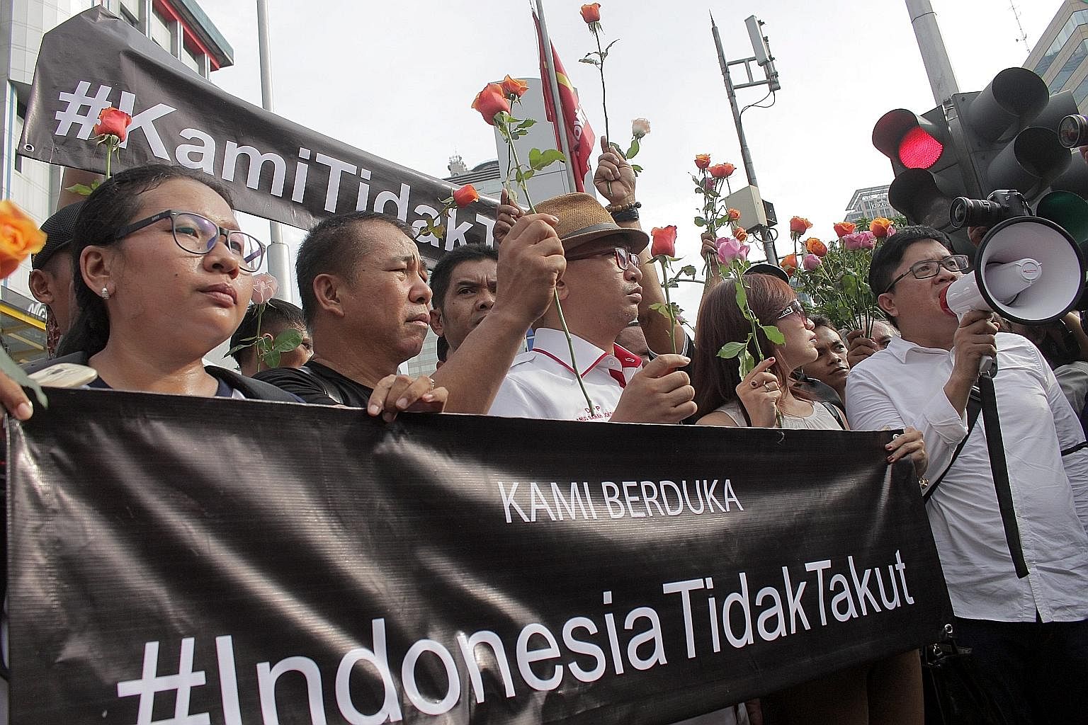 Activists holding a banner last Friday that said "Indonesia is not afraid" at the site of a bombing in Jakarta. The day before, local militants had launched an assault in downtown Jakarta, which left seven dead.