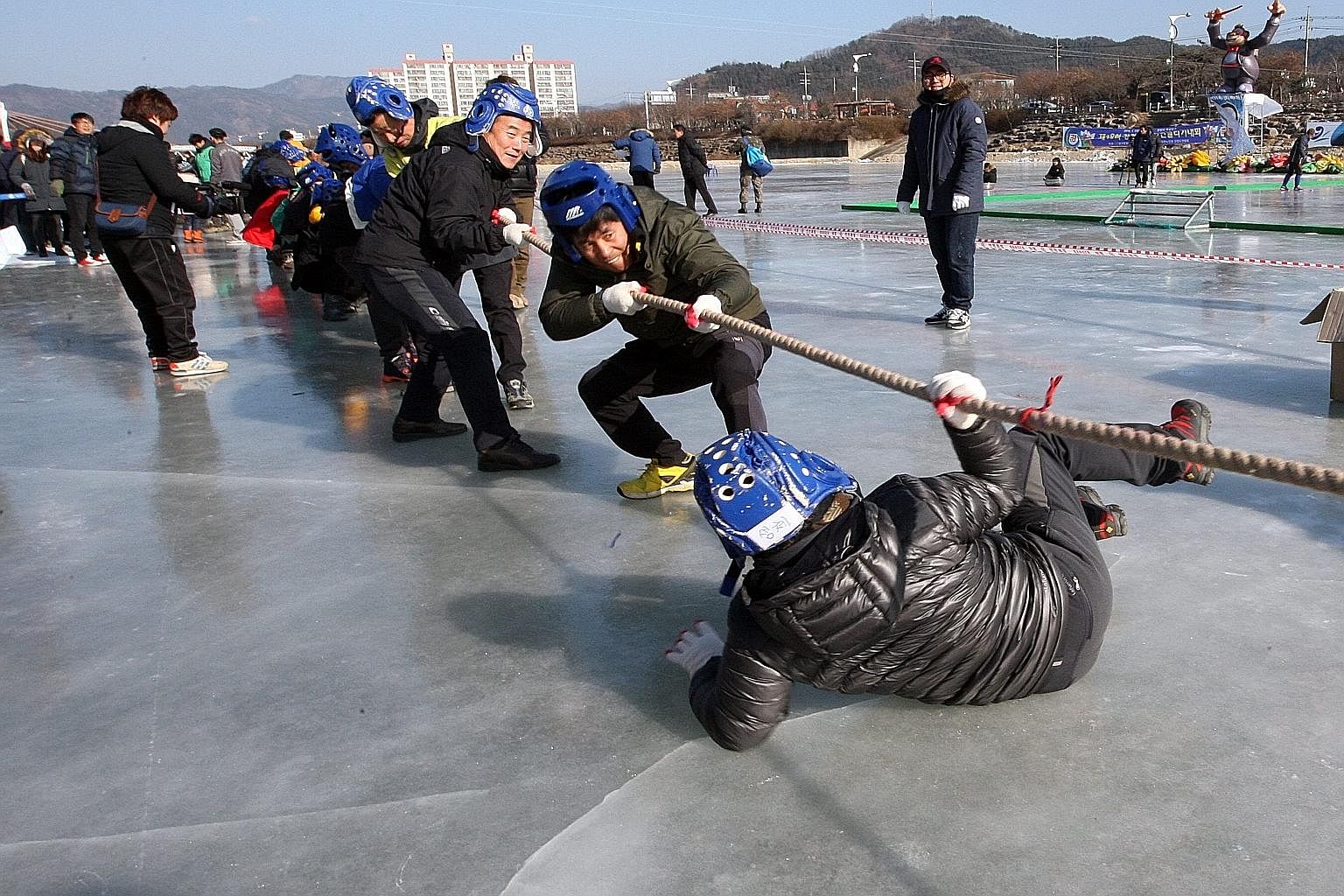 South Koreans enjoying a tug-of-war at a winter festival in Gangwon province over the weekend as the country shivered to a cold wave with temperatures dropping to as low as -20 deg C.