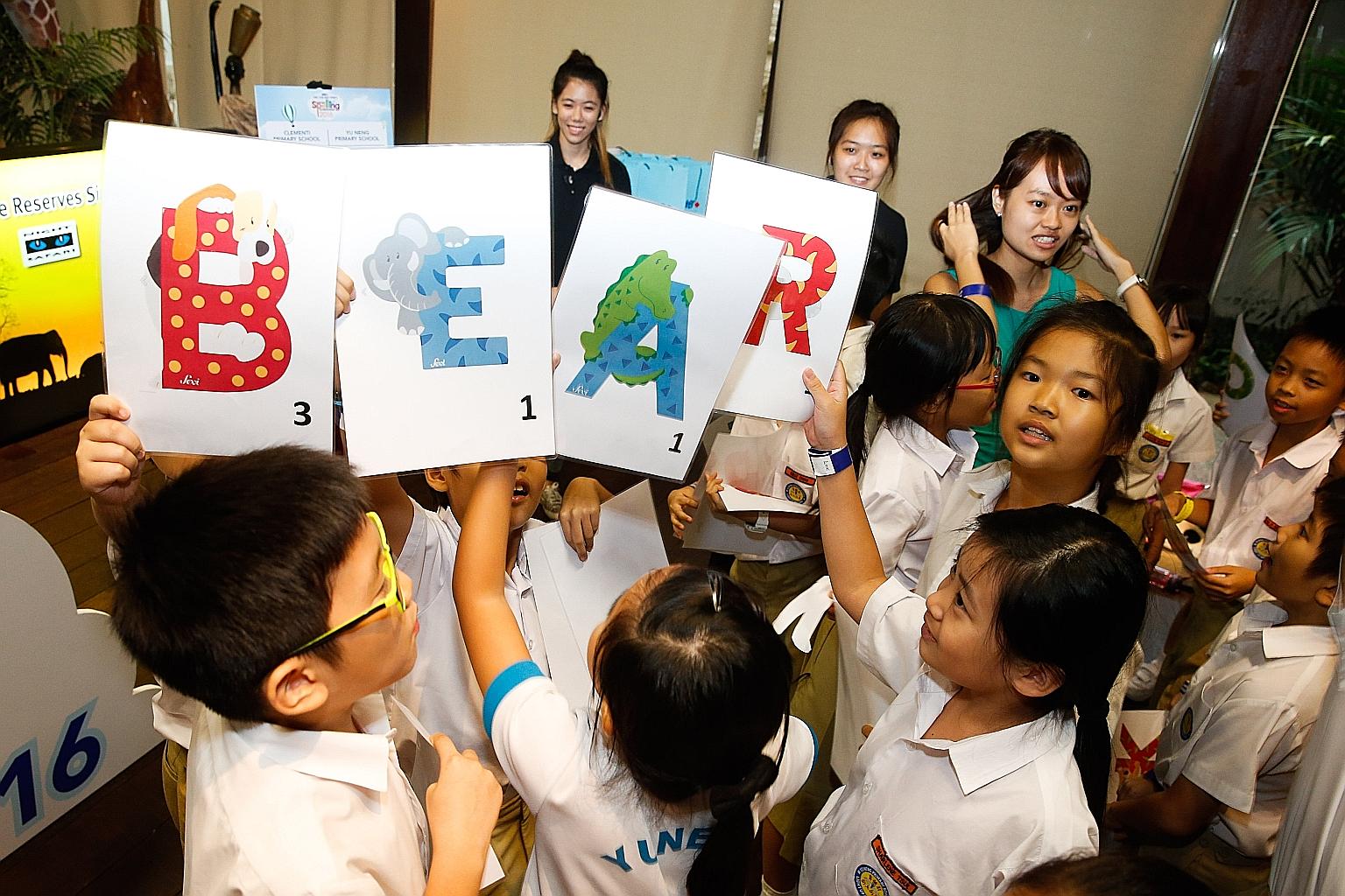 Yu Neng Primary School pupils demonstrating their knowledge of animal names at the Singapore Zoo yesterday, at the launch of the fifth RHB-The Straits Times National Spelling Championship. The most difficult word they spelled, "rhinoceroses", was als