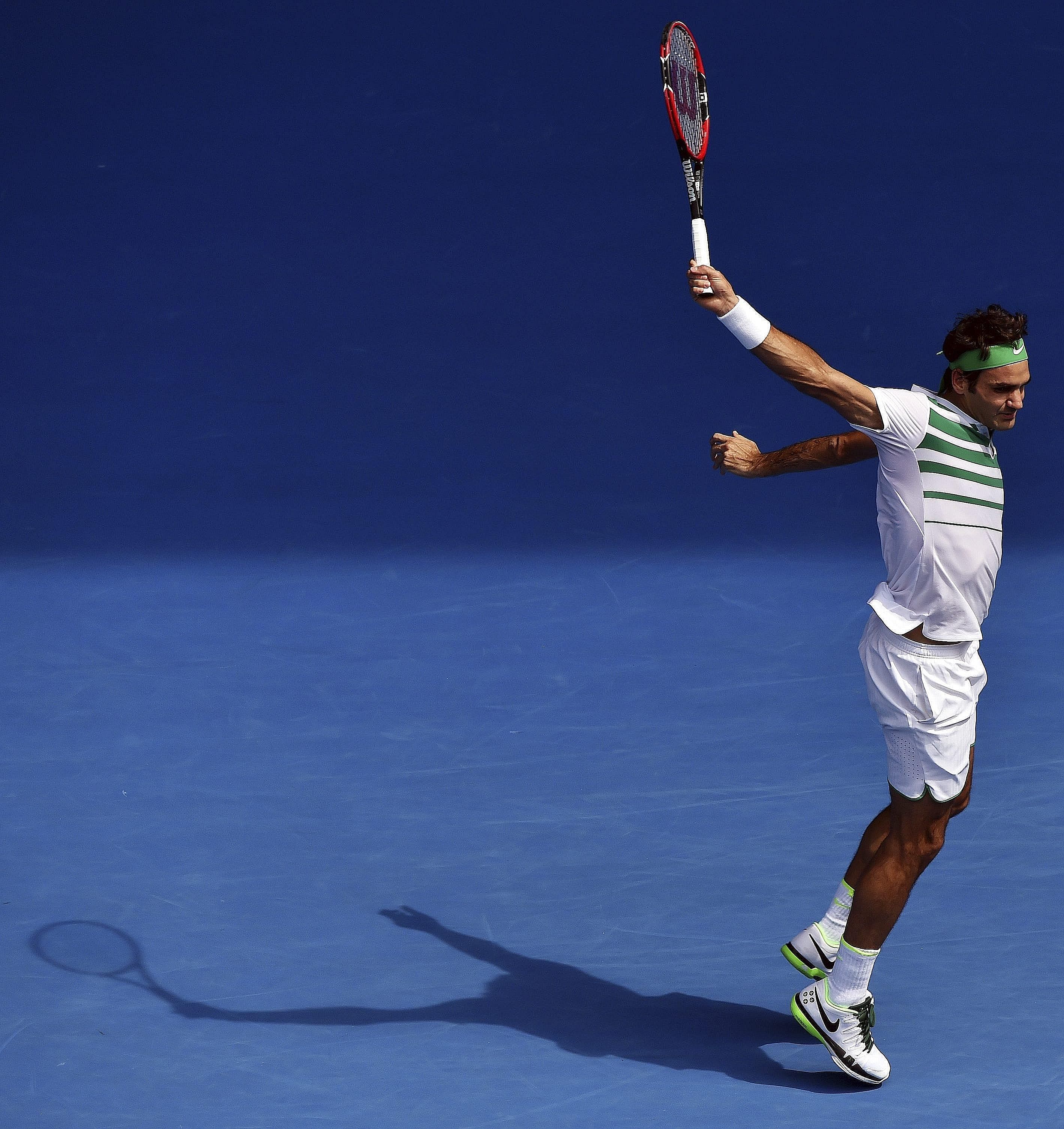 Roger Federer combines poise, balance and grace in his follow-through to a backhand in his Australian Open quarter-final against Tomas Berdych of the Czech Republic at the Australian Open yesterday. Federer dropped his opening service game but won 7-