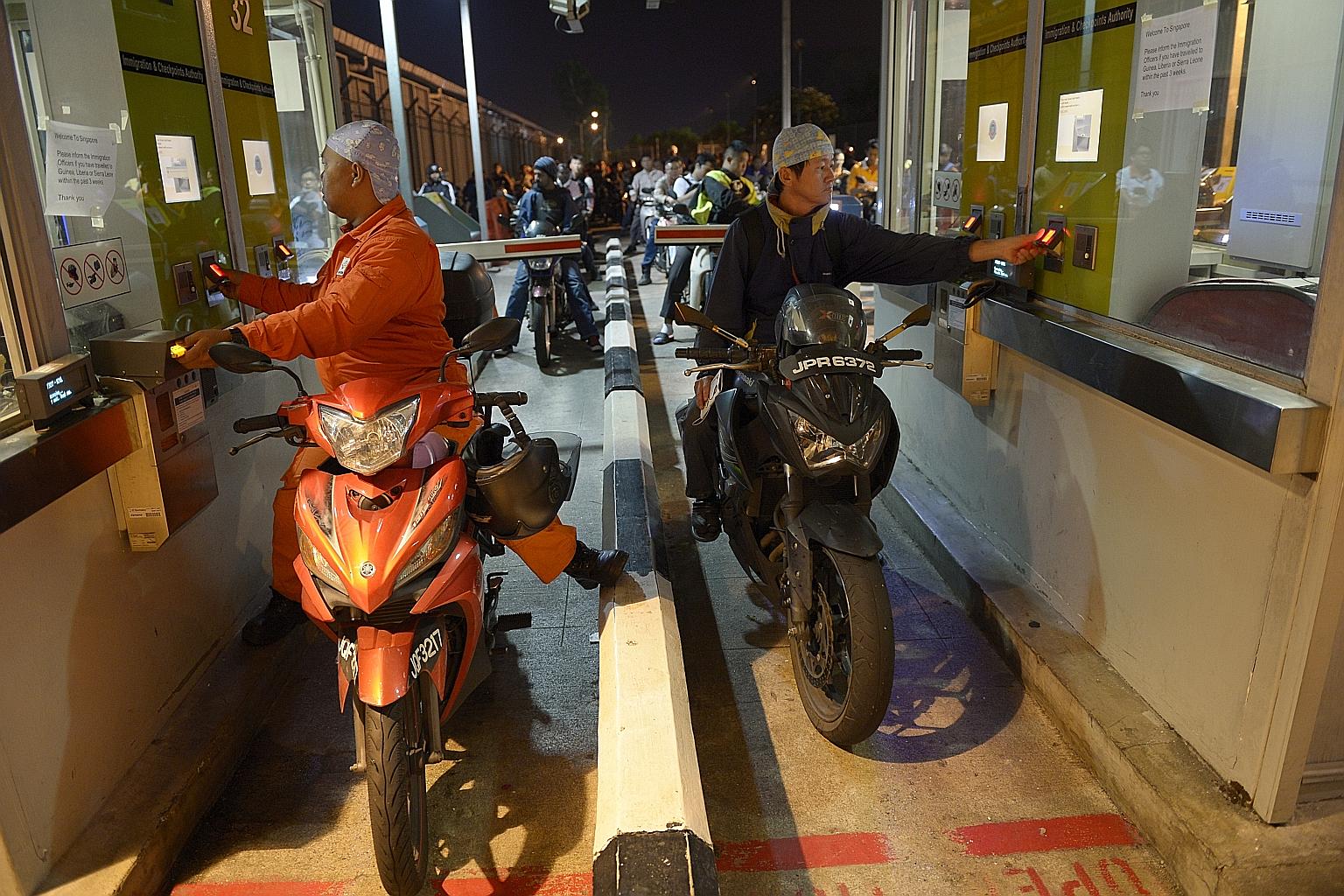 Motorcyclists bound for Singapore scanning their fingerprints while going through the automated clearance channels at Woodlands Checkpoint. Senior Minister of State for Home Affairs Desmond Lee noted that more than half a million people pass through