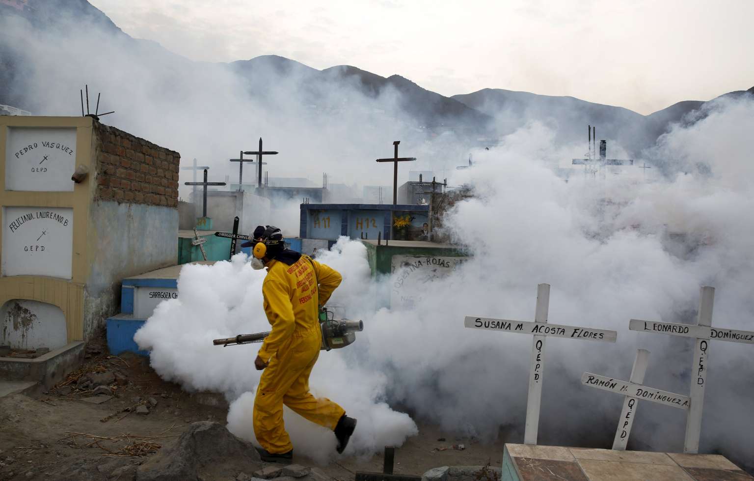 A health worker carries out fumigation in the outskirts of Lima, Peru.