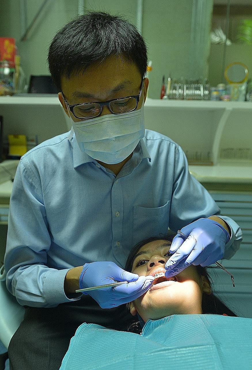 Secondary 2 student Clemente being treated by her dental specialist Tan Kok Liang. She wore a special type of braces made of titanium alloy, which is more flexible than normal ones. She also had them on for just 10 months, a much shorter period than 