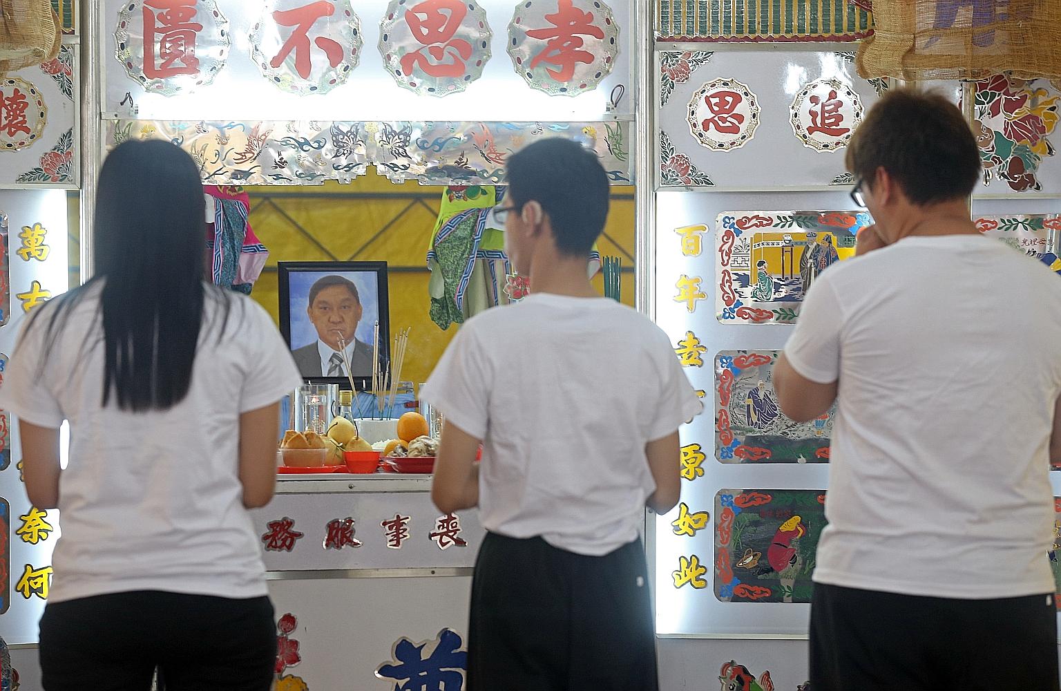 Mr Tan's daughter and 32-year-old son, Junqiang, at his wake yesterday at Teck Whye Avenue. Mr Tan especially doted on Junqiang, who lives in a centre for people with special needs on weekdays, said family and friends.