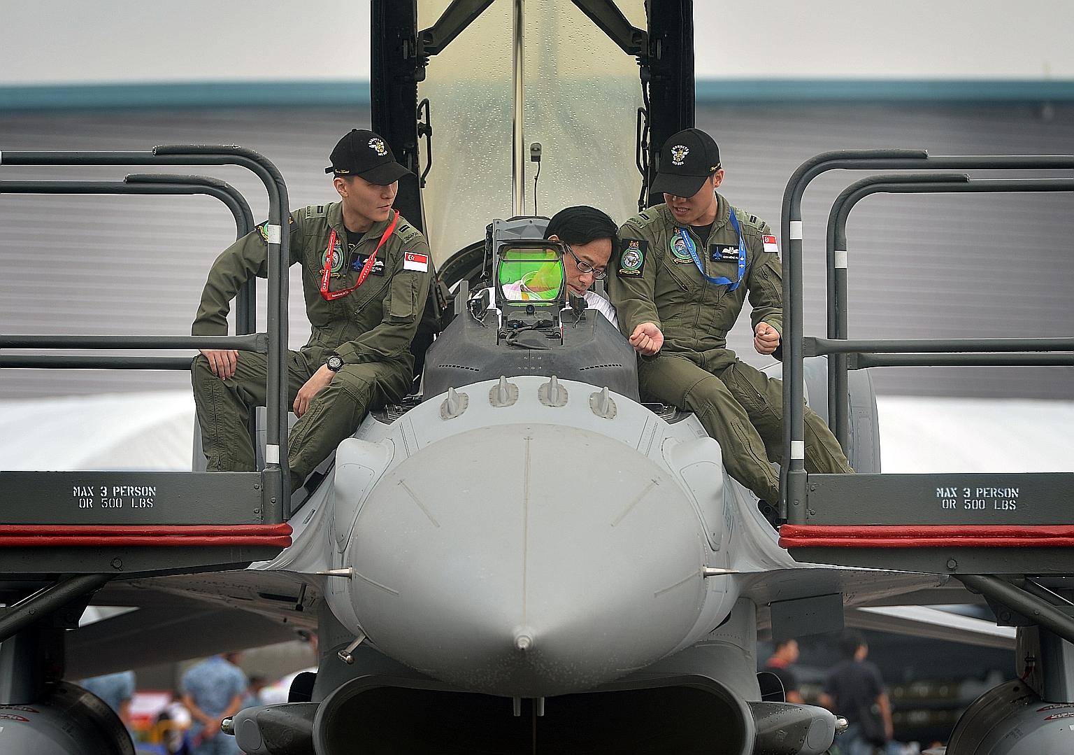 A visitor checking out an F-16D+ fighter aircraft from the Republic of Singapore Air Force on the final trade day of the Singapore Airshow 2016 yesterday. The show grounds at Changi Exhibition Centre will be open to the public this weekend. The airsh