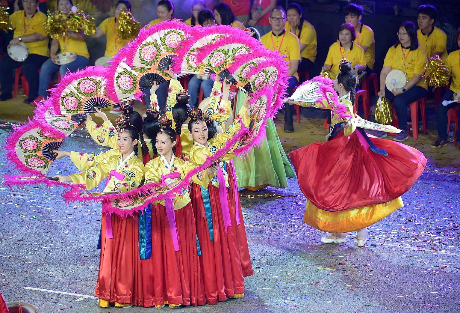 Dancers from South Korea's Yewon Dance Company dazzled the audience last night with a folk dance as part of Chingay 2016. The troupe of women, with their folding fans painted with peonies, fanned out onto the streets to create shifting symmetrical fo