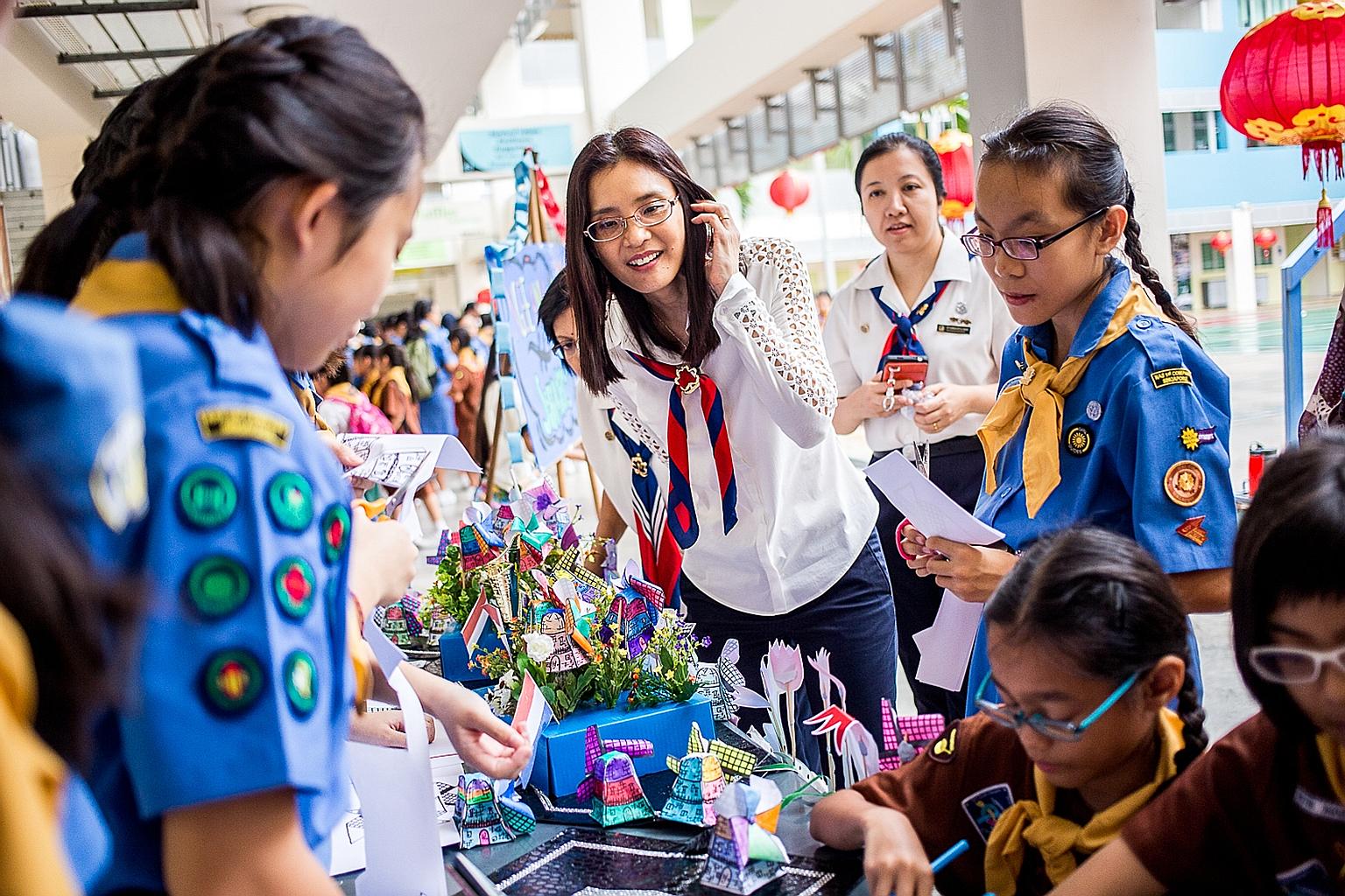 President of Girl Guides Singapore Chang Hwee Nee (centre), who was at Bedok Secondary School, and more than 5,000 members of the Girl Guides Singapore got together yesterday in their north, south, east and west divisions to mark World Thinking Day. 