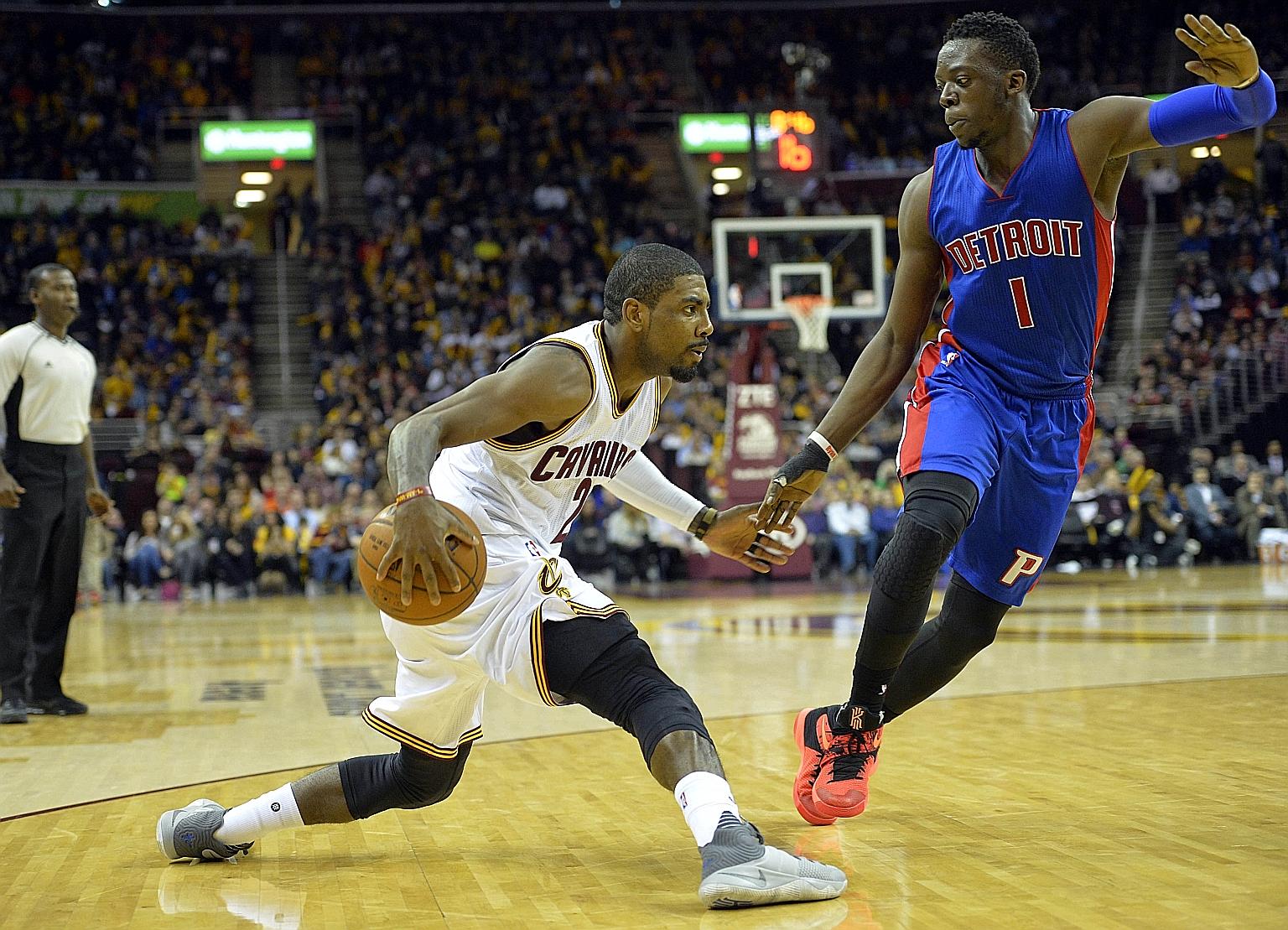 Cavaliers guard Kyrie Irving (left) dribbling against Pistons guard Reggie Jackson during the game on Monday night.