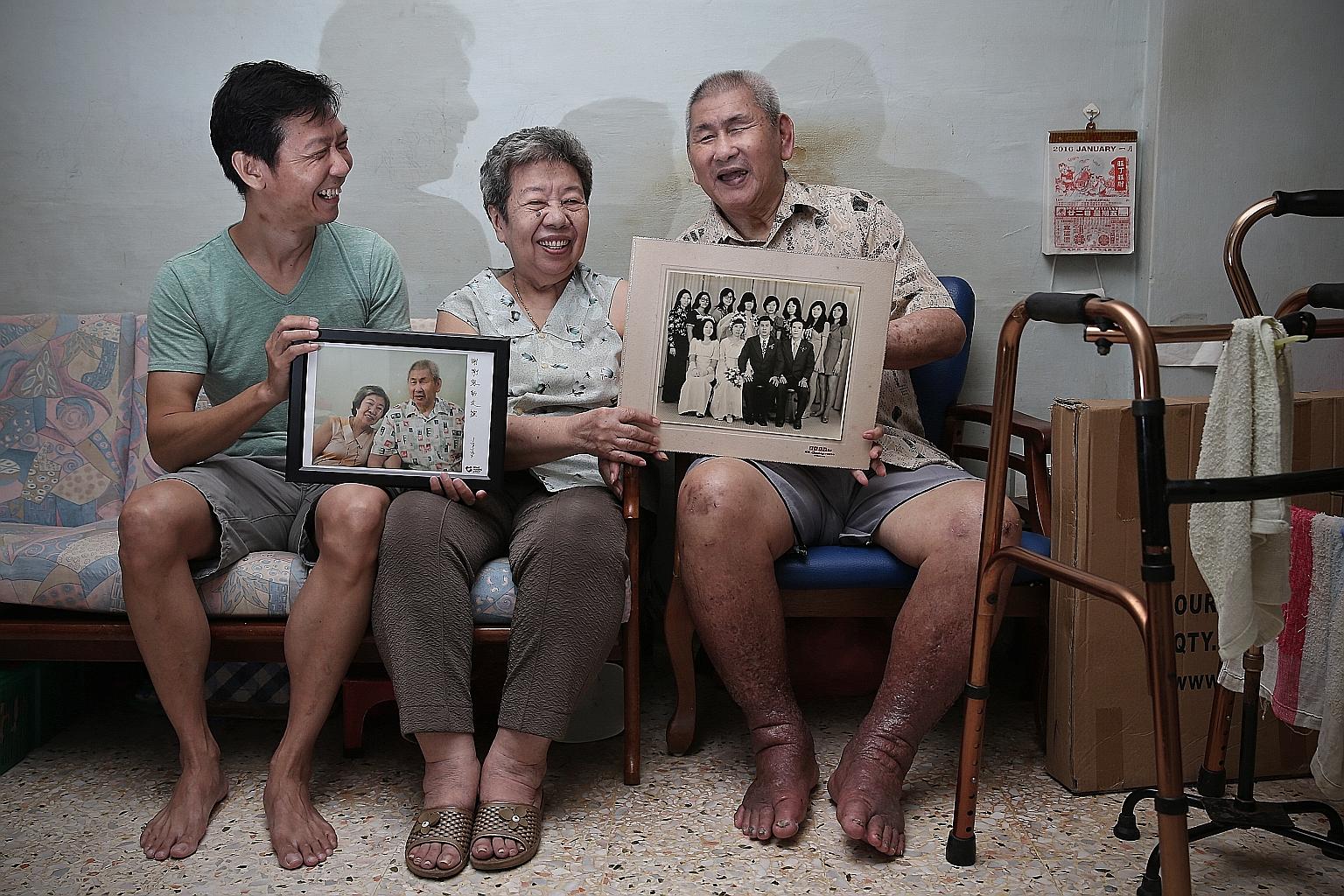 Mr Khoo Piak Choon and Madam Qui Jok Poh with their wedding photo - the only formal picture they had of themselves together until Mr Kelvin Lim (far left) took their portrait for the Home Nursing Foundation.