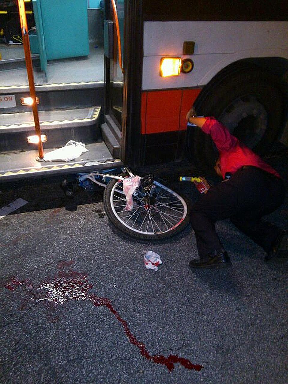 A handout picture taken by the victim's aunt showing the boy's bicycle pinned under the bus. He was riding across the zebra crossing on Choa Chu Kang North 5 when he was knocked down by an SMRT bus and dragged for about 10m. His left foot, which was 