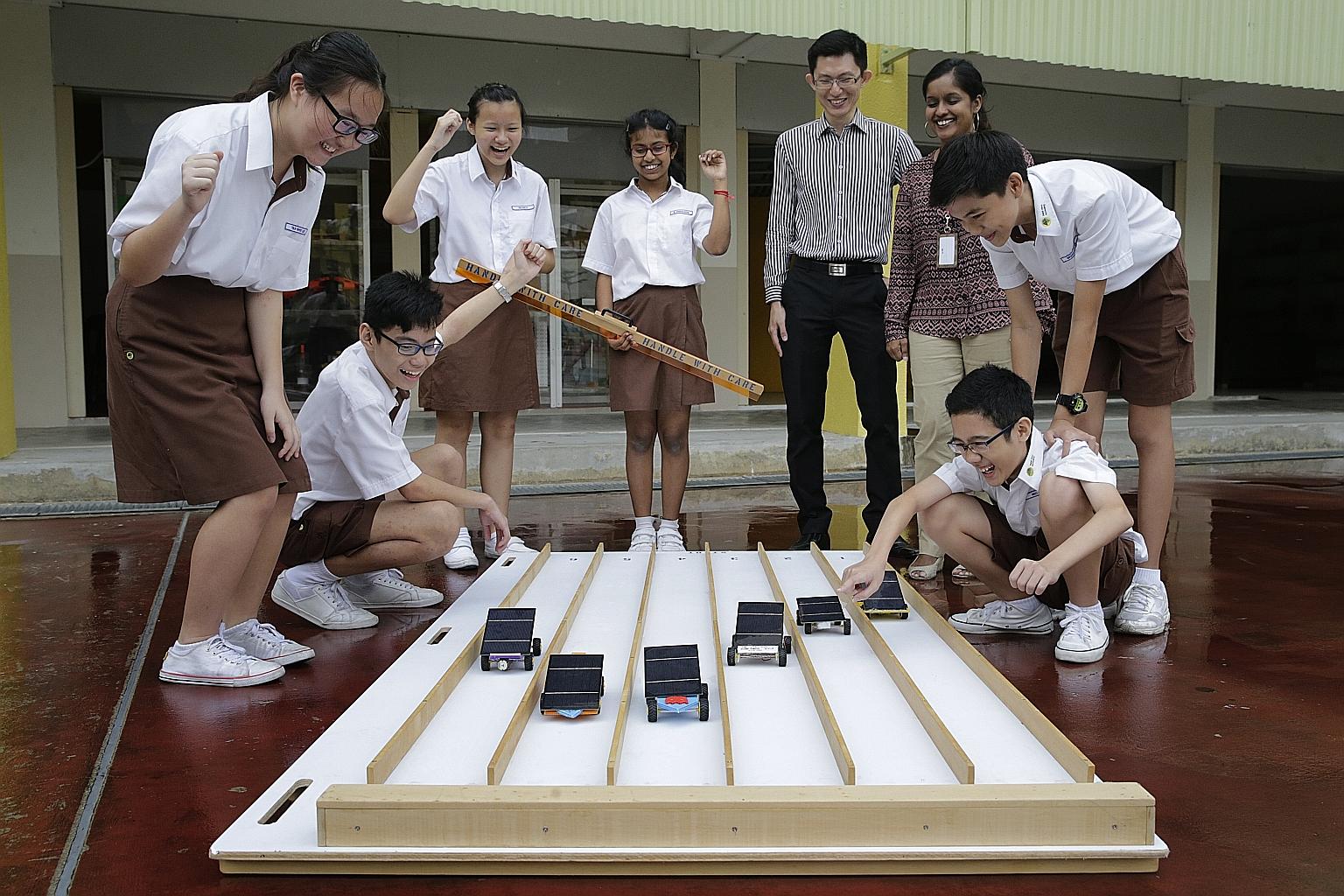 (Clockwise from far left) Bukit View Secondary School students Tan Whee Lee, 14; Nicholas Chong, 13; Tio Hui Li, 13; M. Charulatha, 13; head of department for science Ng Wuay Boon, 38; level head for science and Applied Learning Programme Reena Lloyd