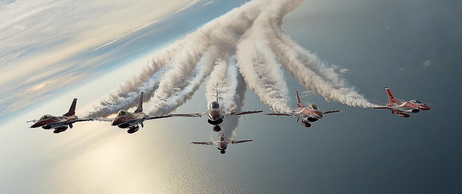 The Black Knights - the Republic of Singapore Air Force aerobatics team - flying in formation over the South China Sea during a training session in preparation to celebrate Singapore's jubilee year. This photo, "Ready to soar for Singapore's Golden J