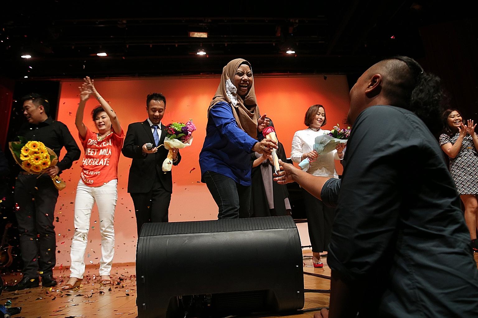Ms Fazslindah (in blue) receiving a rose from her husband during the grand finale of a charity concert yesterday. The Songbirds - Where Dreams Take Flight matinee is the first large-scale fundraiser by Daughters Of Tomorrow.