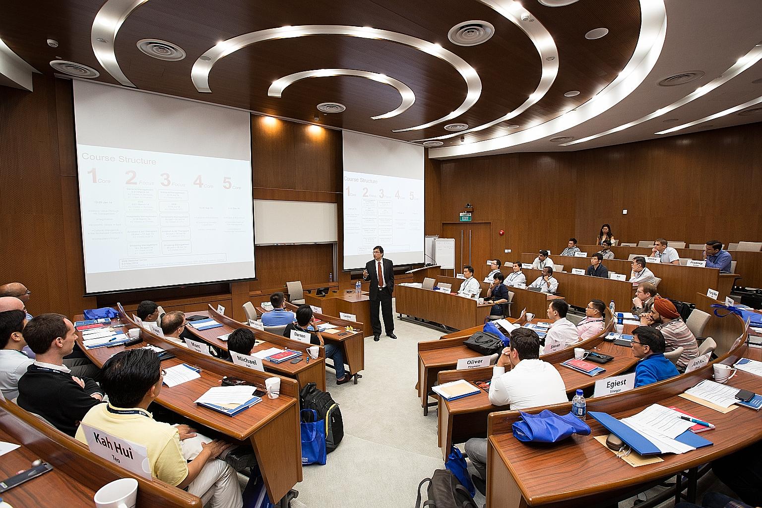 A class at Nanyang Technological University. Graduates from its business and computing double degree programme took home a gross median monthly salary of $4,583 last year. This put their salaries almost on a par with those who studied law or medicine