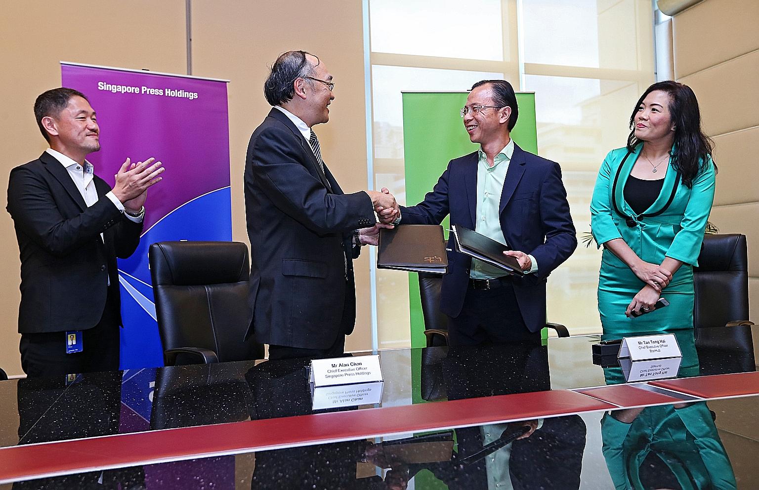 SPH chief executive Alan Chan (left) and StarHub chief executive Tan Tong Hai at yesterday's signing of the memorandum of understanding, under which both firms will tap opportunities in the converged media space.