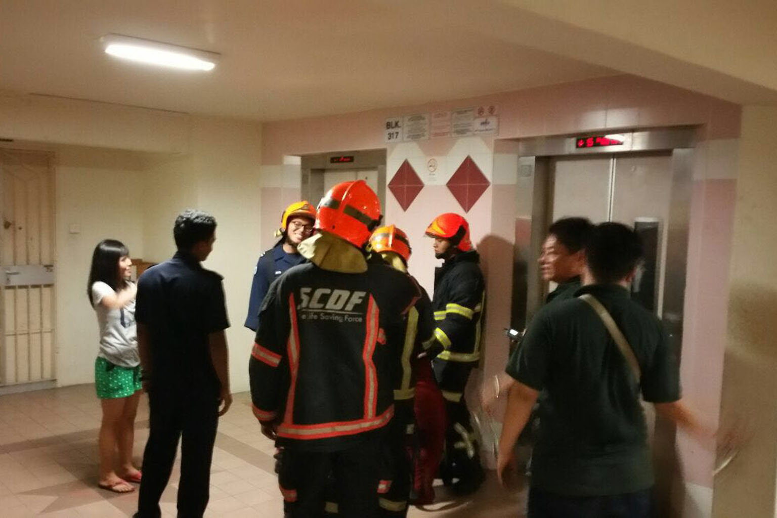 Ms Evi Lisnawati (far left), who is from Indonesia, was on her way to pick up her employer's children when she got stuck in the lift at Block 317 in Ang Mo Kio Street 31.