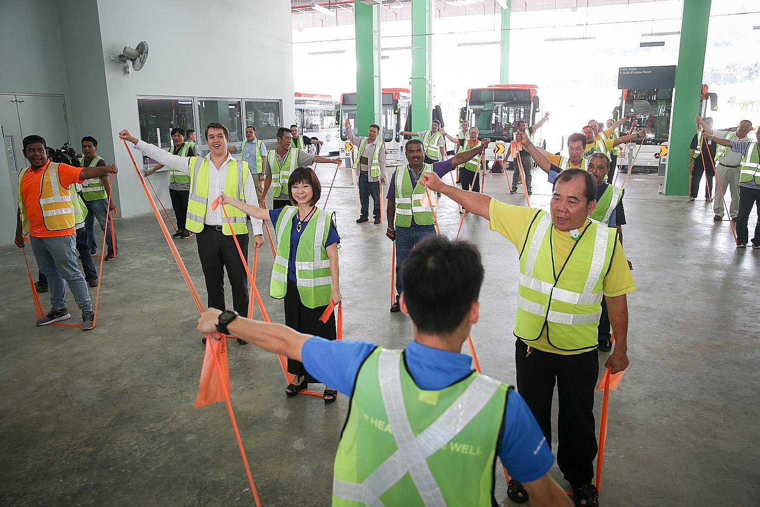 Senior Minister of State for Health Amy Khor (centre) taking part in an exercise session with bus drivers at Bulim Bus Depot yesterday. The Starting Right programme is a partnership between Tower Transit and the Health Promotion Board to inculcate he