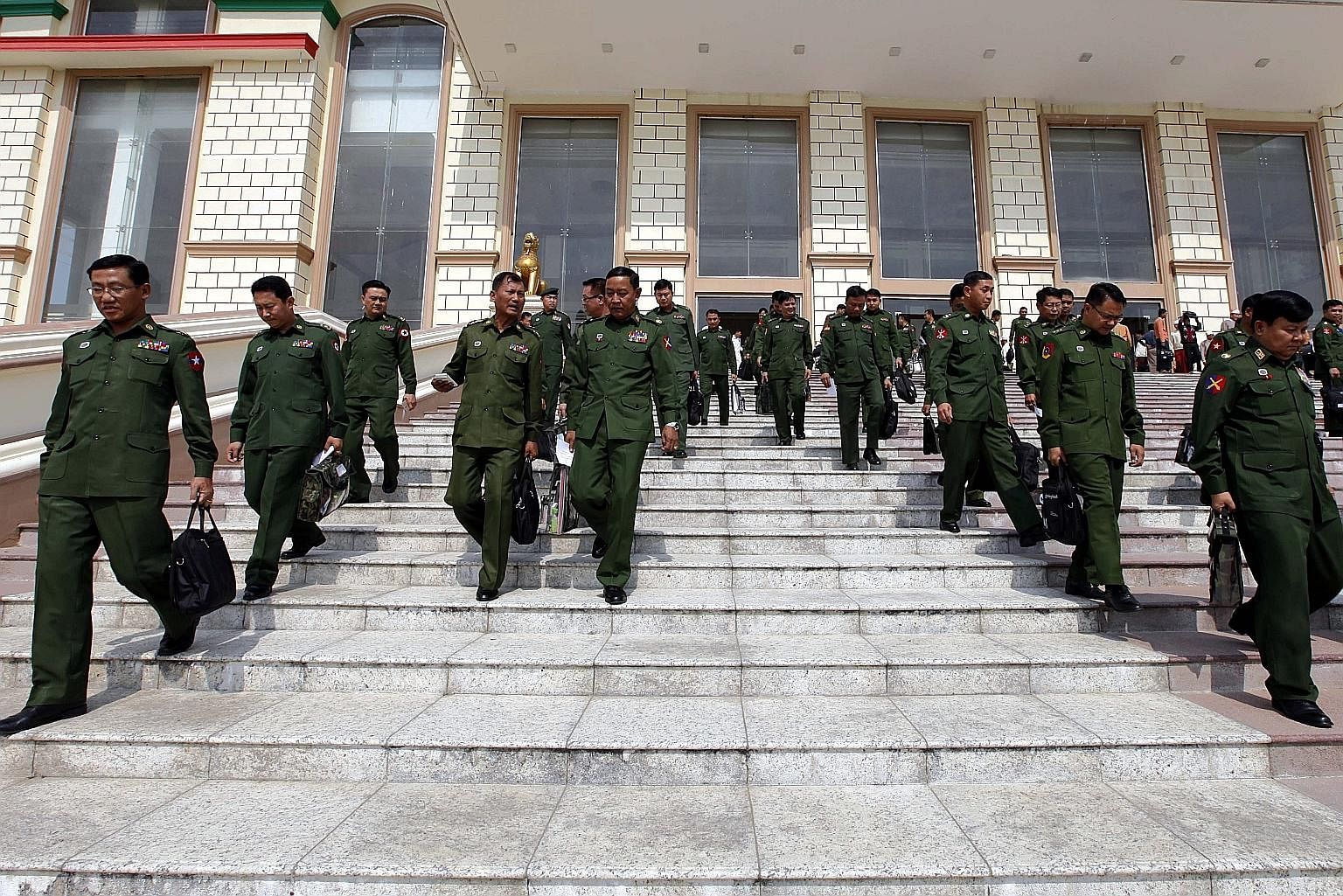 Military representatives leaving after a regular session of Parliament in Naypyitaw on March 1. Recent developments have suggested that the present military leadership is intent on sustaining its influence on the country's politics at least for the n