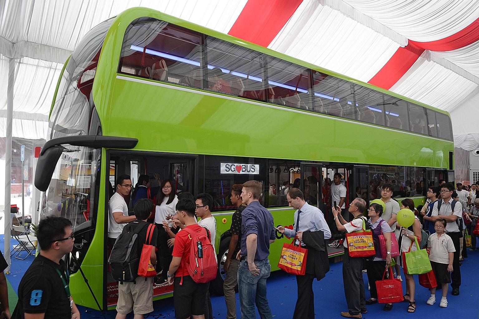 One of two concept double- decker buses, featuring three doors and two stairways, on display at the Bus Carnival at Ngee Ann City yesterday. Visitors can give feedback on the features and configuration of the buses. The carnival ends tomorrow but wil