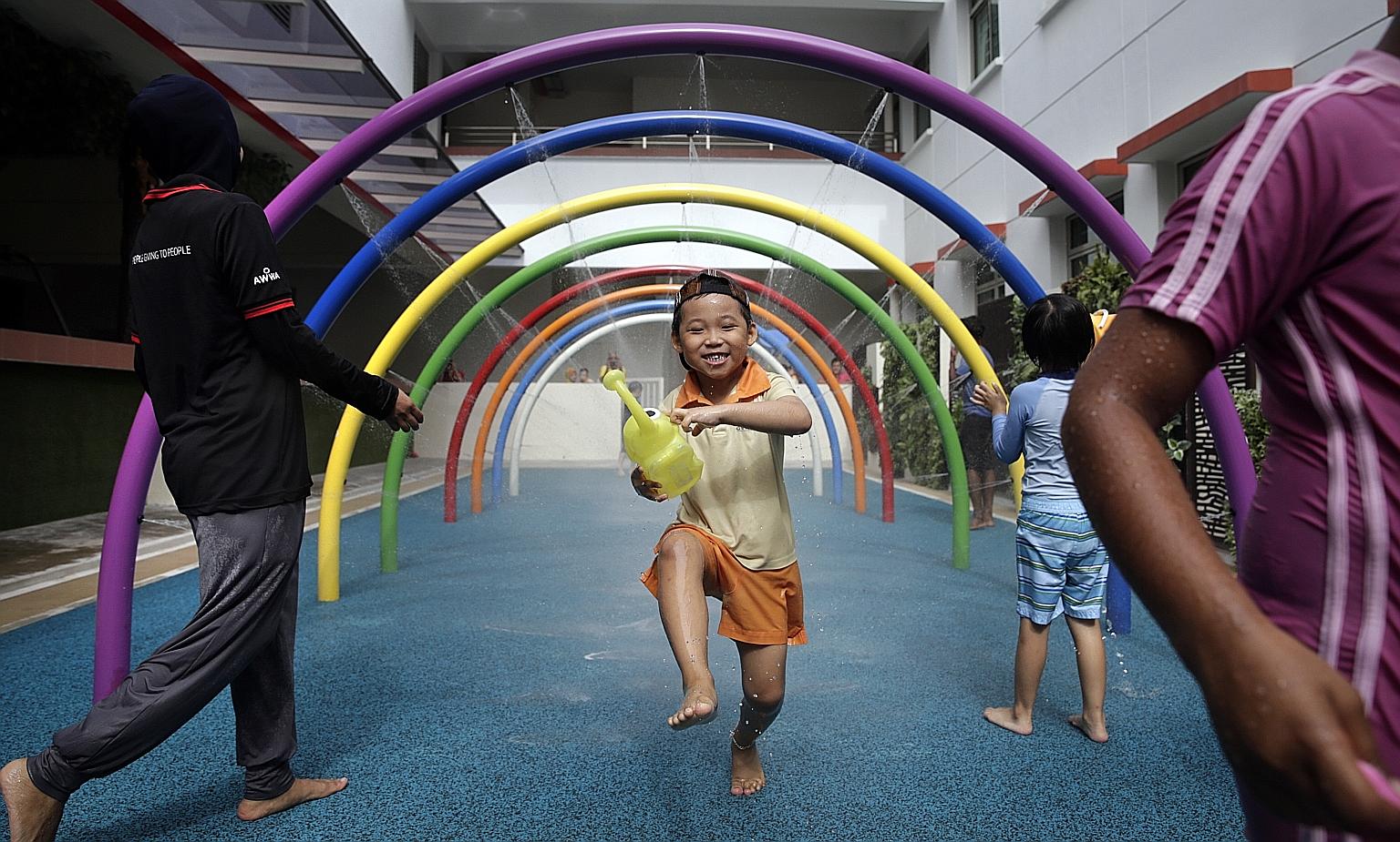 James Lim Yu Hong, a six-year-old pupil attending the AWWA Early Intervention Centre, has a whale of a time playing in the wet area of a new sensory playground installed in AWWA School. The playground, which has wet and dry areas, will help children 