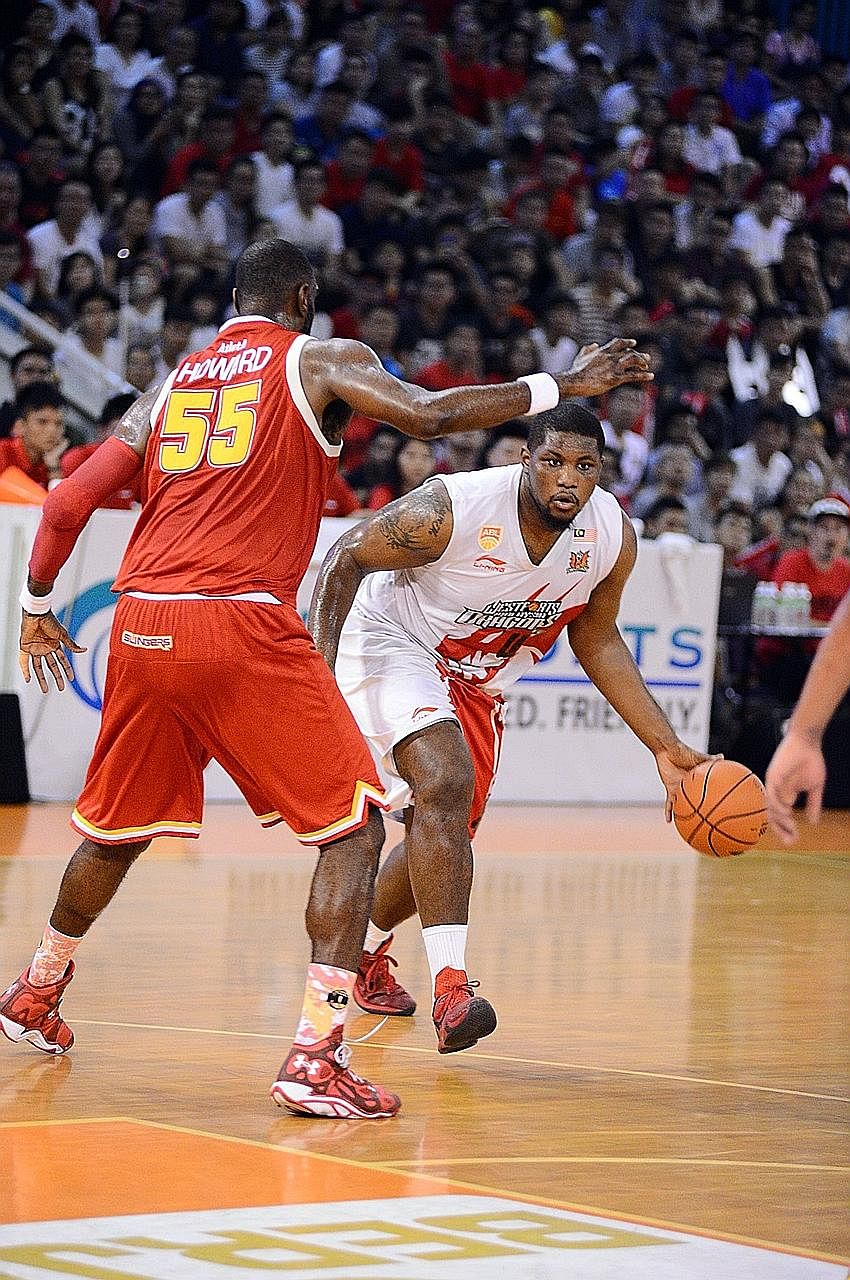 A battle between two centres, as the Slingers' Justin Howard (left) defends the Dragons' Reginald Johnson. While Howard had a game-high 24 points, Johnson led a balanced Dragons attack for the Game Two win.