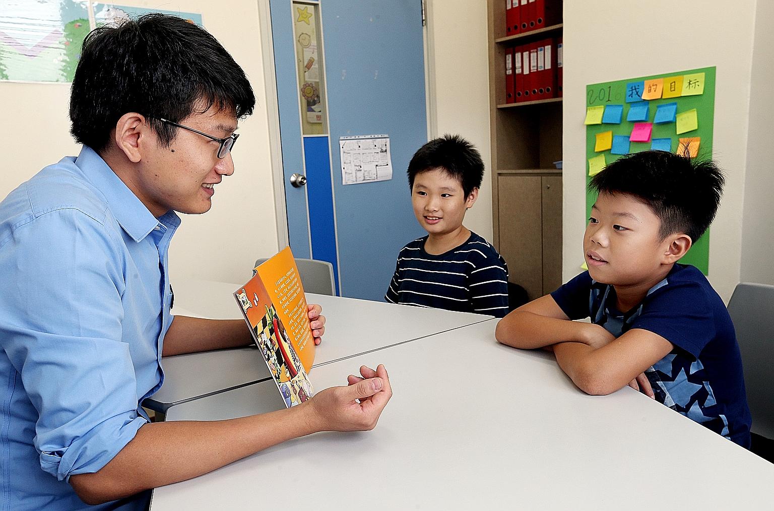 Teacher Li Dong with (from left) Lee Jia Le, 10, and Ng Jun Rui Elgin, 10, during a Chinese literacy class at DAS.