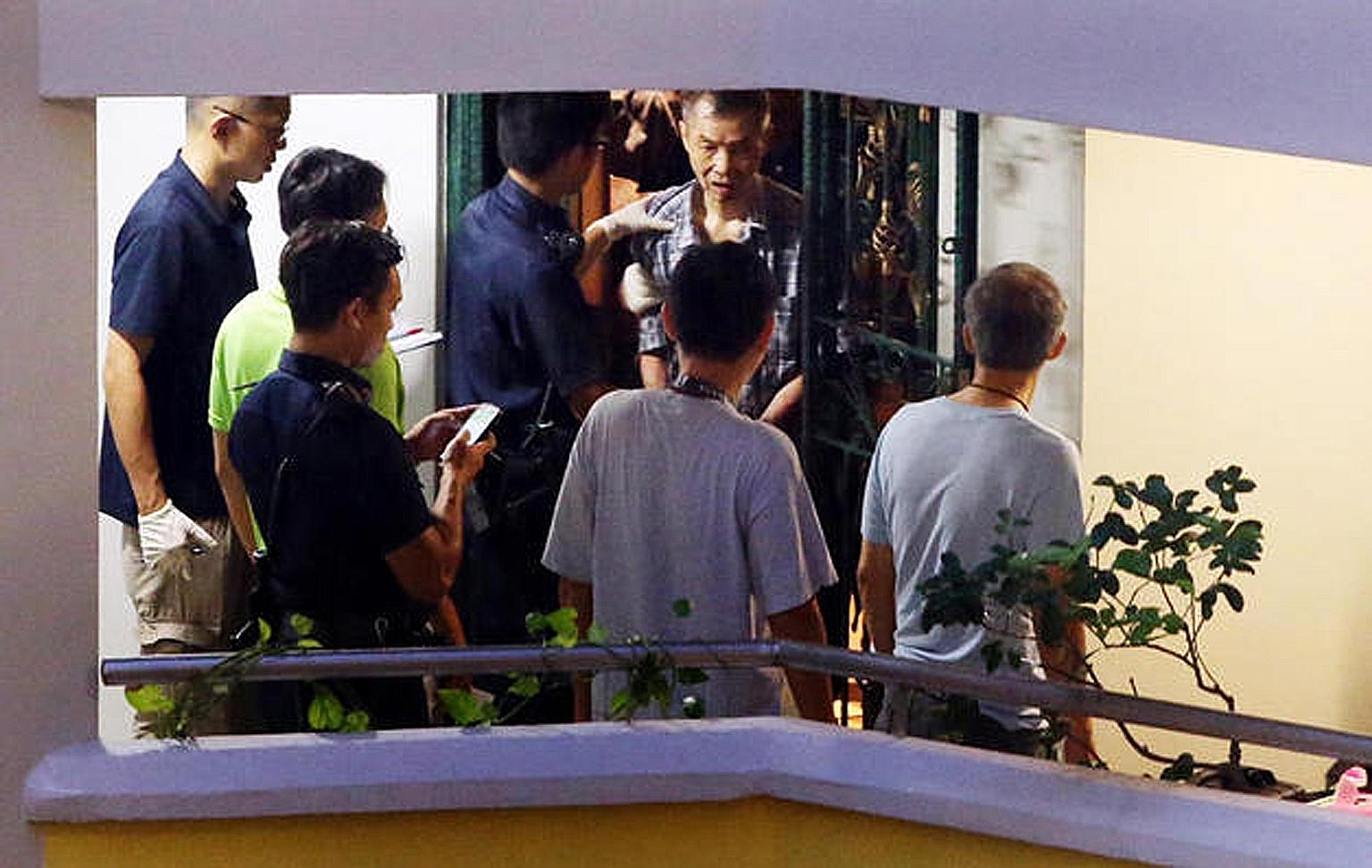 Kong Peng Yee being led away by police officers on Sunday. He is accused of causing the death of his wife, Madam Wong Chik Yeok, 63. The couple had been described by a neighbour as "very loving". Kong, 68, will be remanded for psychiatric evaluation.