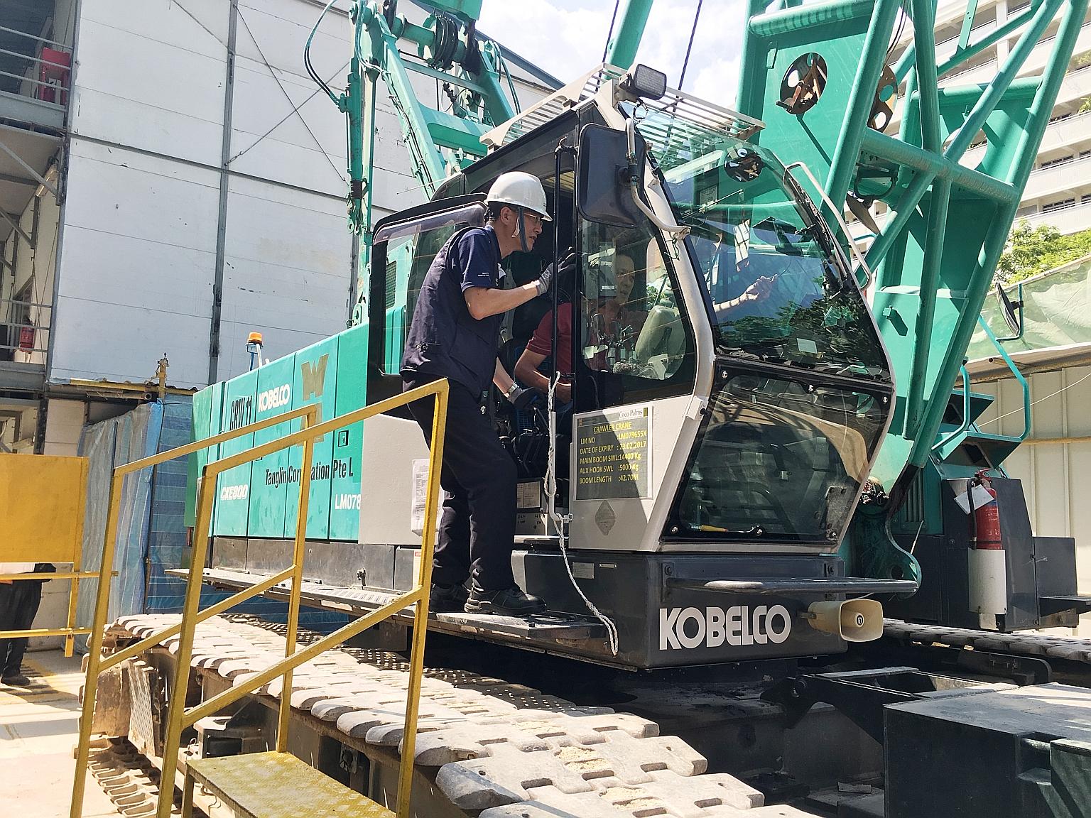 Mr Tan inspected machinery operations and safety features during his visit to the Coco Palms condo construction site yesterday.