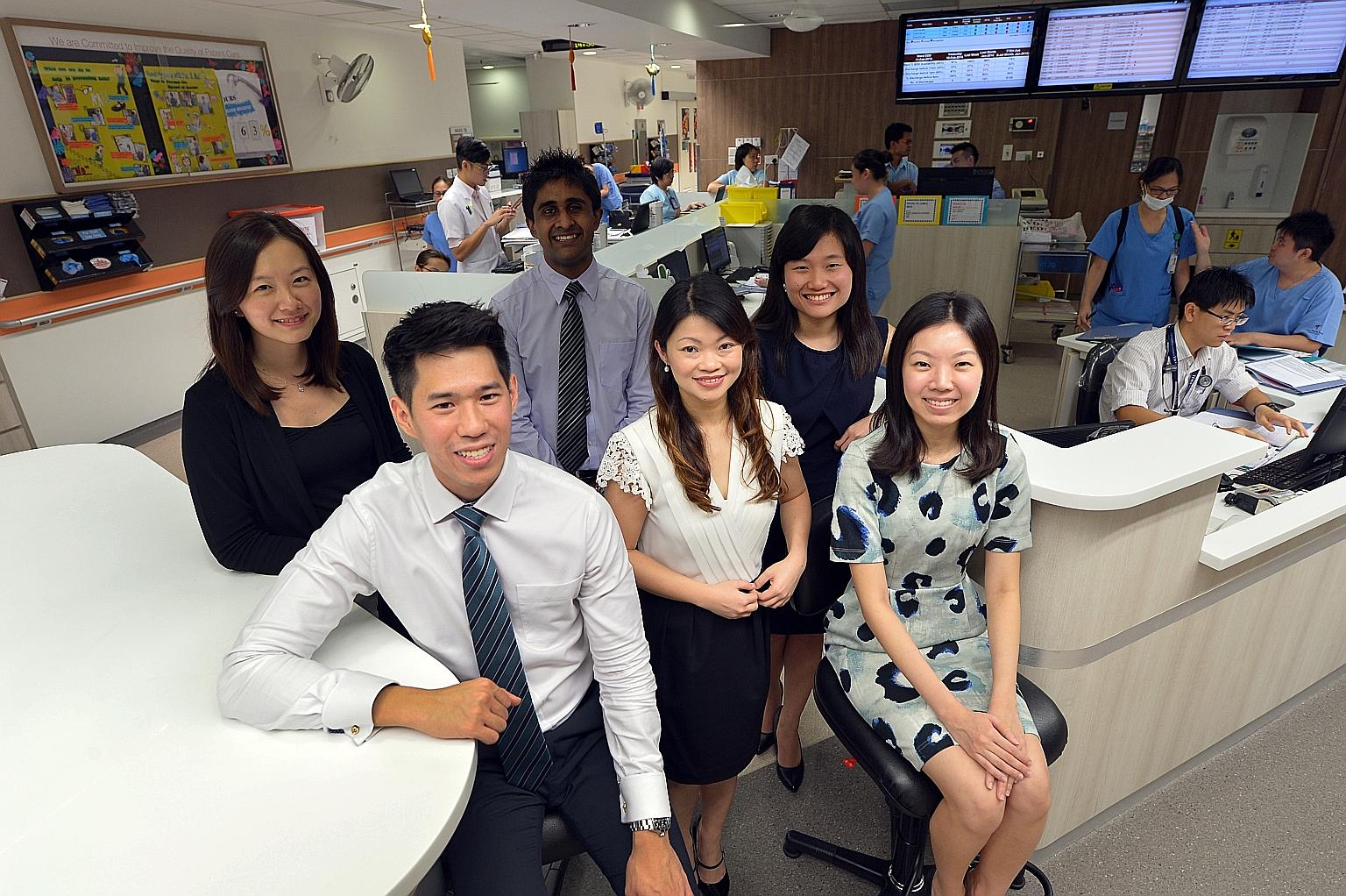 Management fellow Melanie Kam, 35 (centre, in white blouse and black skirt), with current and former management associates at Tan Tock Seng Hospital. They are (clockwise from left) Ms Teo Kaiting, 29; Mr Mohamed Razeen, 26; Ms Suriani Poh, 29; Ms Che