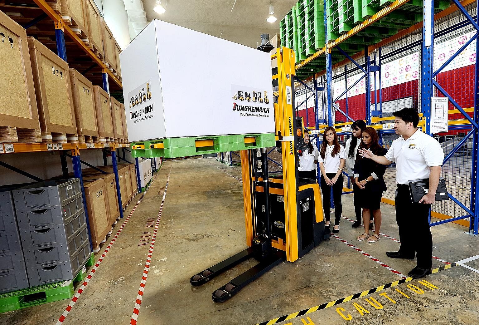 Students on the Earn and Learn Programme for the logistics industry learning about the driverless forklift at the Supply Chain Innovation Lab at Republic Polytechnic.