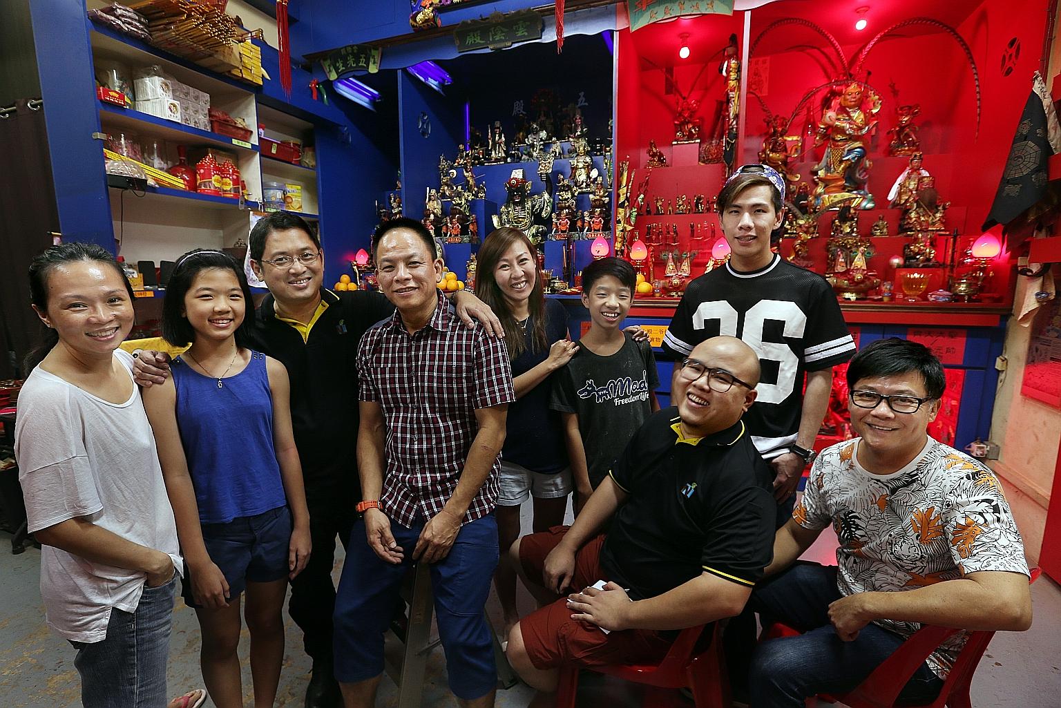 (From left) Ms Louisa Wi, 44, Lia Tan, 12, temple founder Joel Tan, 45, Mr Eddie Png, 47, Ms Jamie Ang, 35, Josiah Tan, 14, Mr Edmund Koh (seated), 27, Mr Kelvin Soon, 35, and Mr Jeffrey Ong, 54, are committee members at Yun Yin Dian temple, where yo
