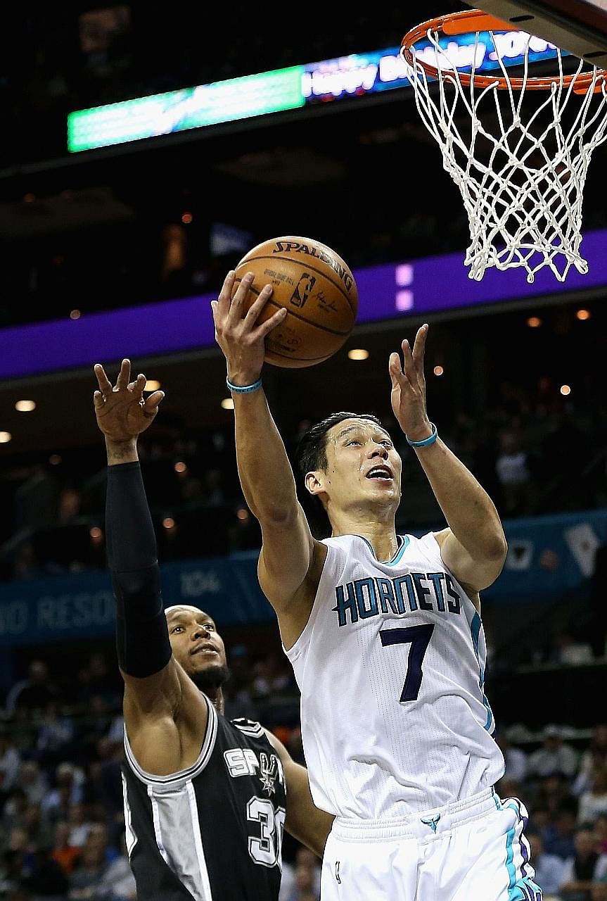 Charlotte's Jeremy Lin driving to the basket against San Antonio's David West at Time Warner Cable Arena. Lin scored 29 points, including four three-pointers, as the Hornets defeated the Spurs 91-88.