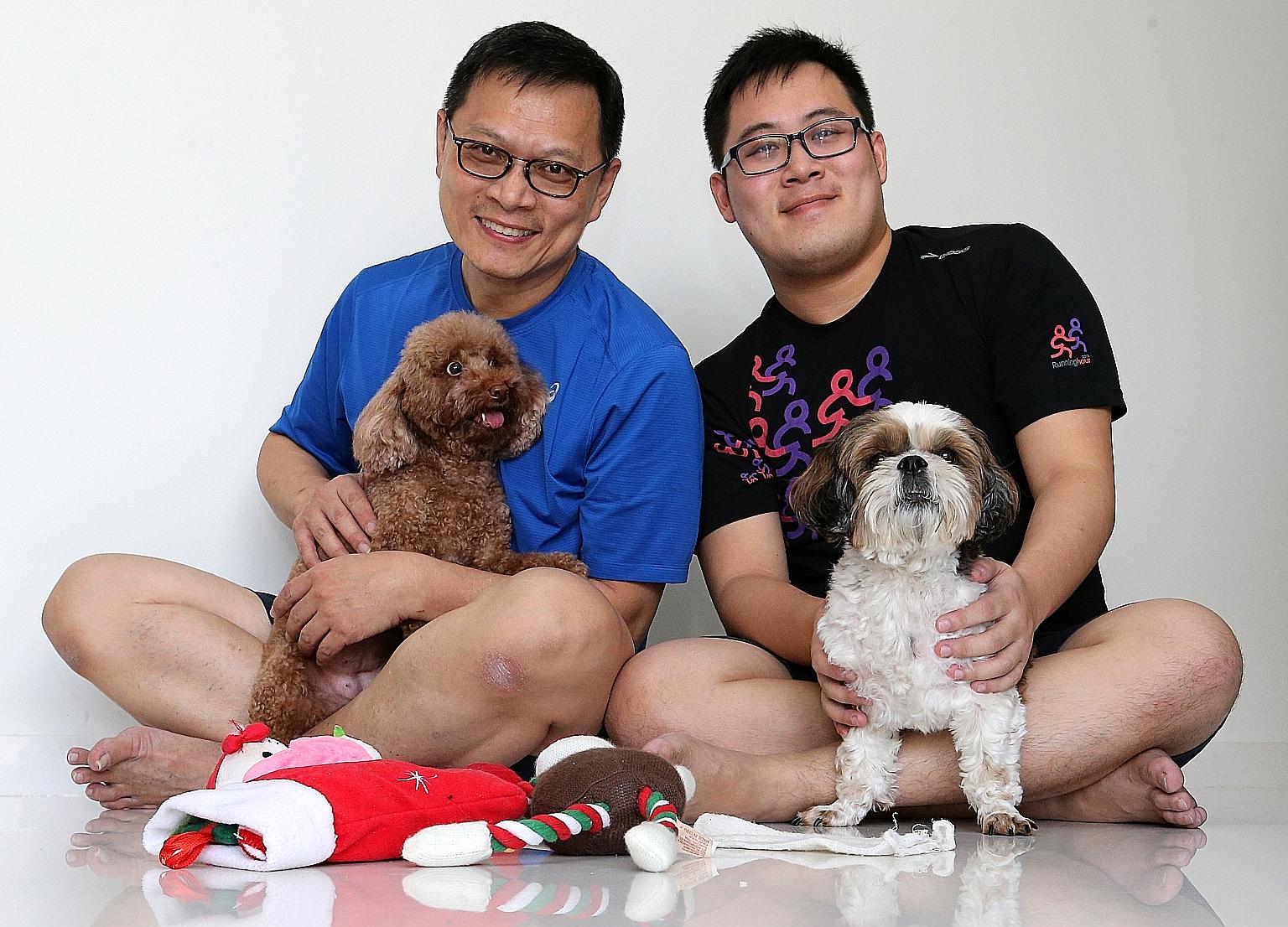 Mr Patrick Soh (left), 55, cuddles his toy poodle, while his son, Mr Dominic Soh, holds their shih tzu, which his parents bought for companionship after the NTU student and his sister moved to hostels.