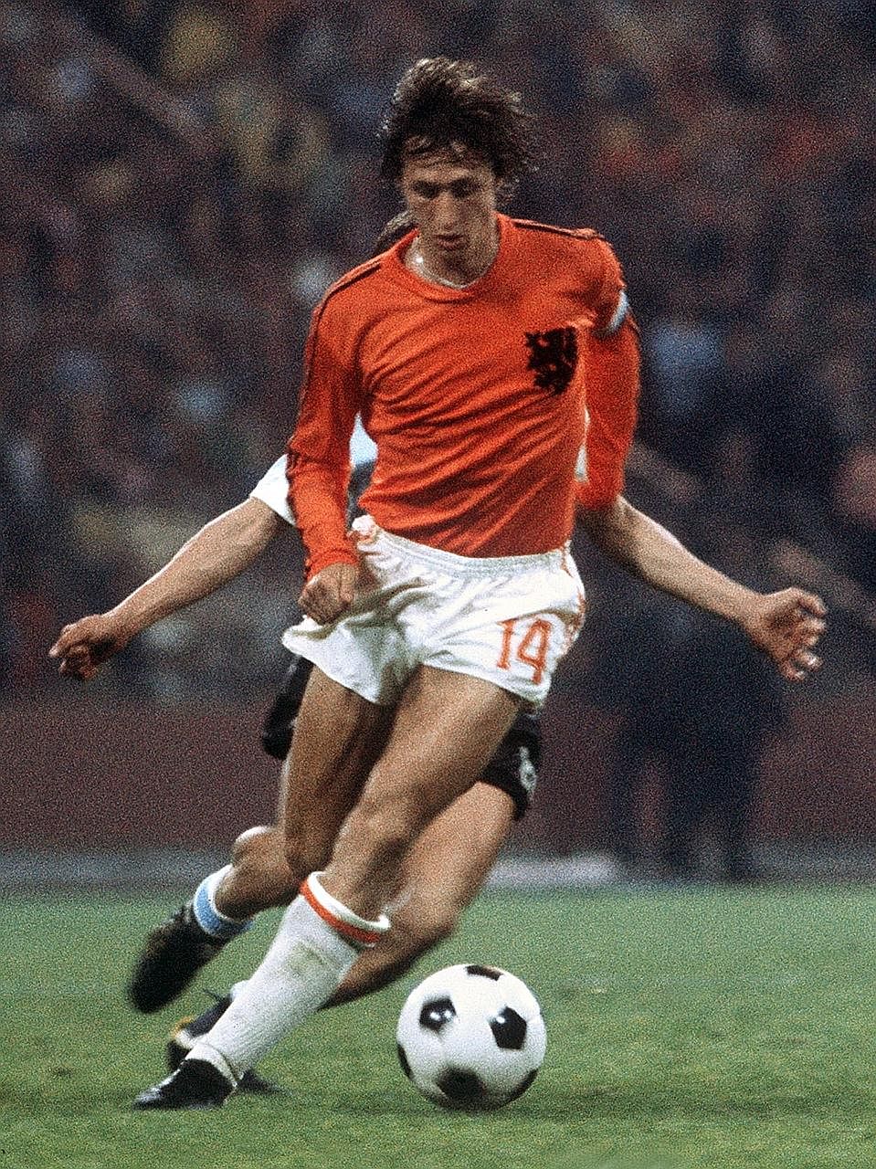 A 1974 photo showing the late Dutch forward Johan Cruyff controlling the ball under pressure from a West German player during the World Cup final in Munich which was won by the host nation.