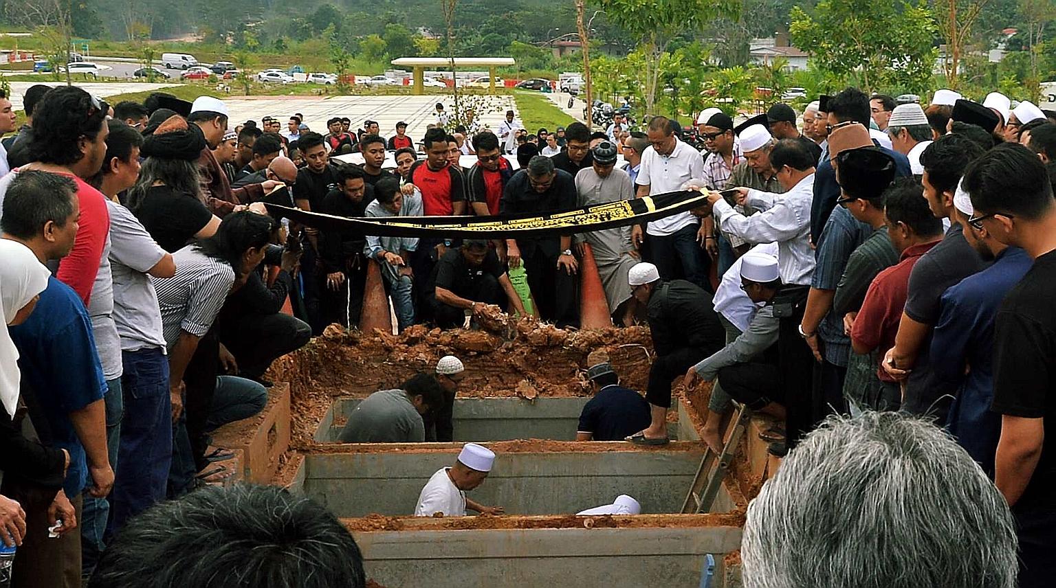 The funerals of SMRT trainees Muhammad Asyraf and Nasrulhudin at the Muslim cemetery in Lim Chu Kang on Wednesday. The two men were killed on Tuesday when they were hit by an oncoming train.
