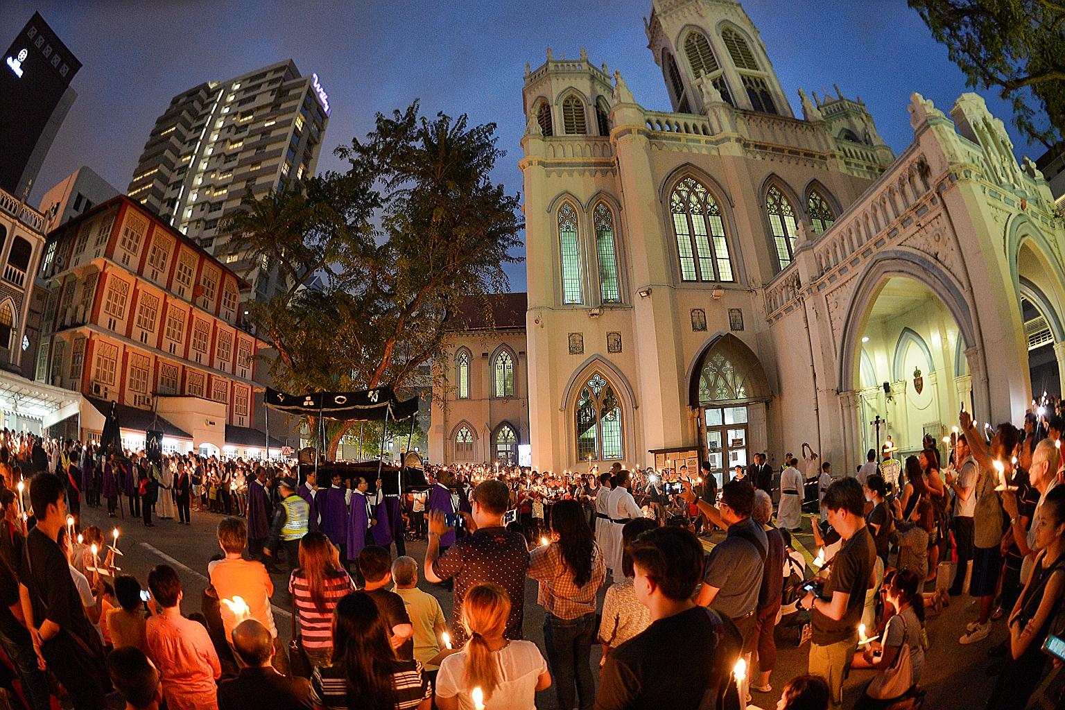 Worshippers attending the evening service at St Joseph's Church in Victoria Street yesterday, where a 191-year-old life-size wooden statue of Christ was carried around the church compound on a bier.