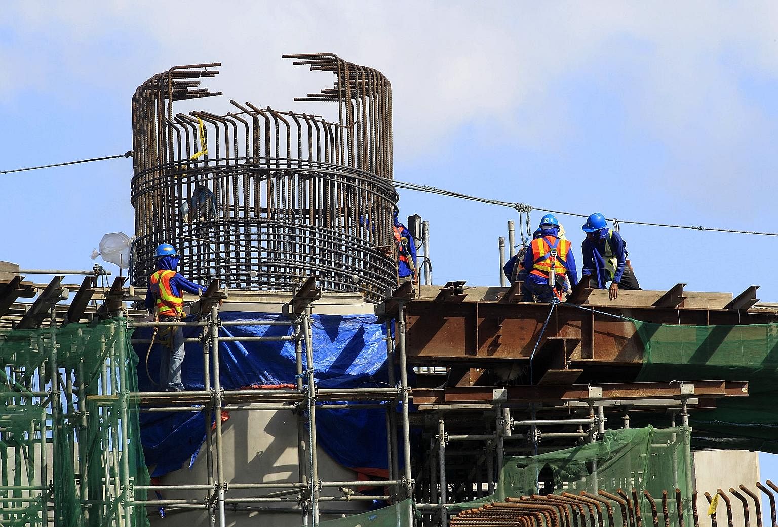 Workers work on an expressway undergoing construction in Manila.The Philippine government is focusing its infrastructure works in the development of ports, expressways and energy projects. Rising urbanisation in countries, such as Indonesia, will spu