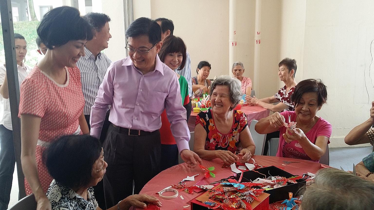 (Standing, from left) Tanjong Pagar GRC MP Joan Pereira, Finance Minister Heng Swee Keat and Senior Minister of State for Health Amy Khor with elderly residents at Thong Kheng Senior Activity Centre in Bukit Merah yesterday. Mr Heng gave more details