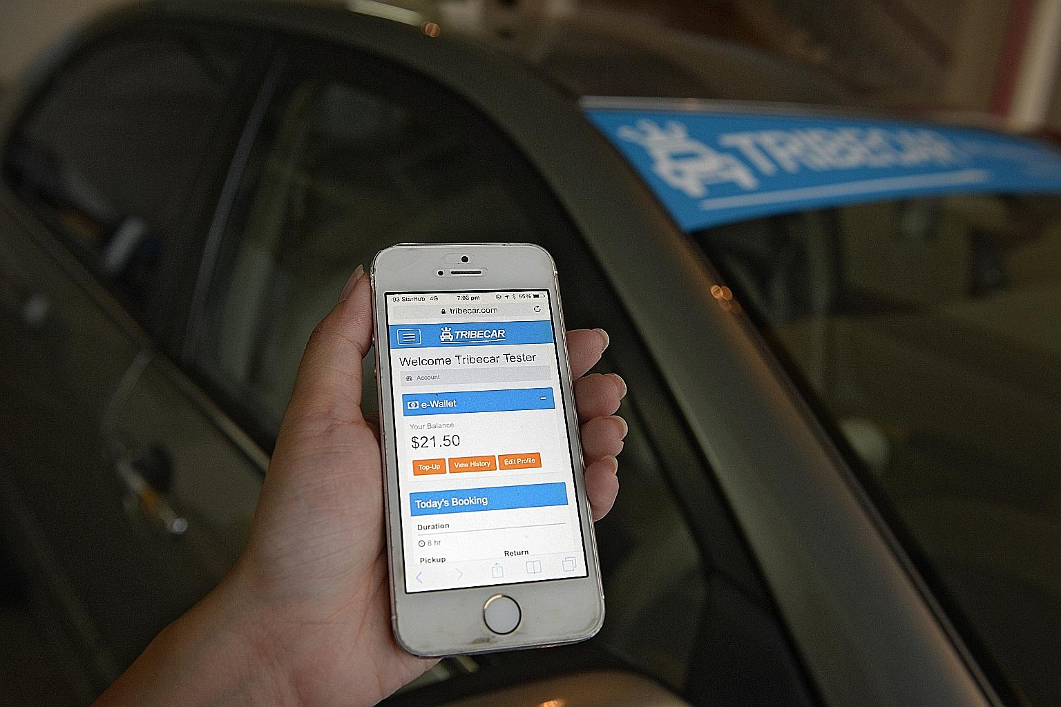 A Tribecar employee demonstrating how to unlock one of the start-up's vehicles using her smartphone yesterday. The company, which currently has a fleet of 23 cars with 210 hirers signed up, aims to expand to 500 cars by year end.