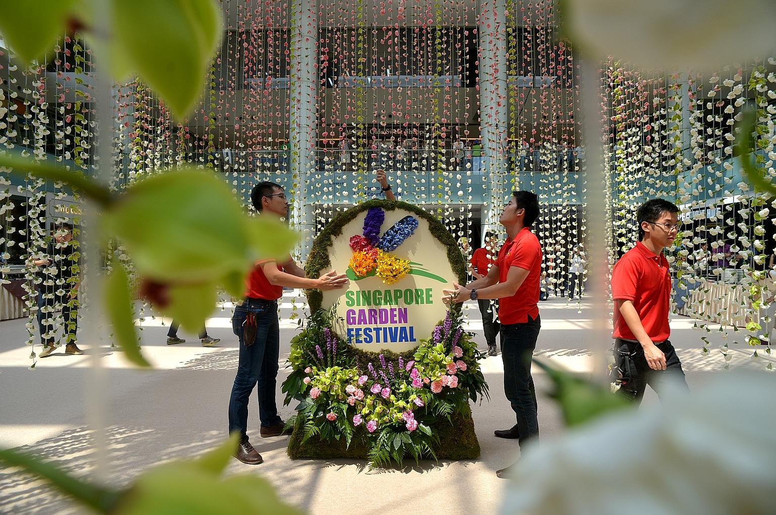 Workers putting the finishing touches to the the world's largest floral chandelier, made from more than 60,000 flowers, which set a Guinness World Record.