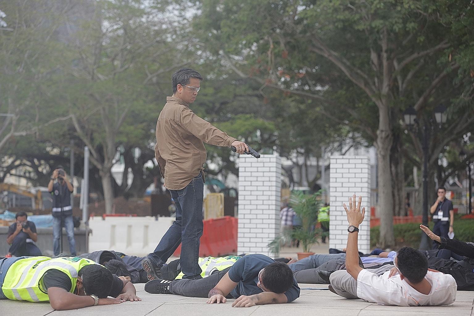 A "gunman" carrying out a simulated attack at Esplanade Park in an anti-terror exercise last year. Mr Shanmugam has described the new SG Secure initiative as not just another public awareness campaign but a "call to action".