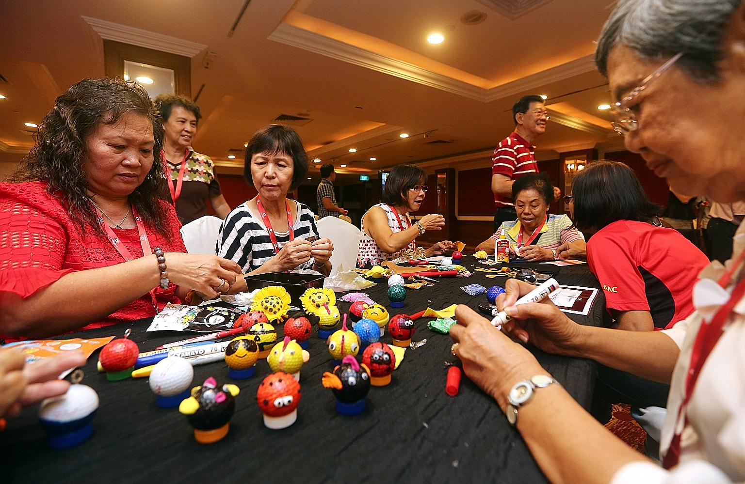 Seniors from Aljunied GRC and Hougang SMC making ornaments out of used golf balls yesterday to raise funds for wellness-related programmes in their areas.