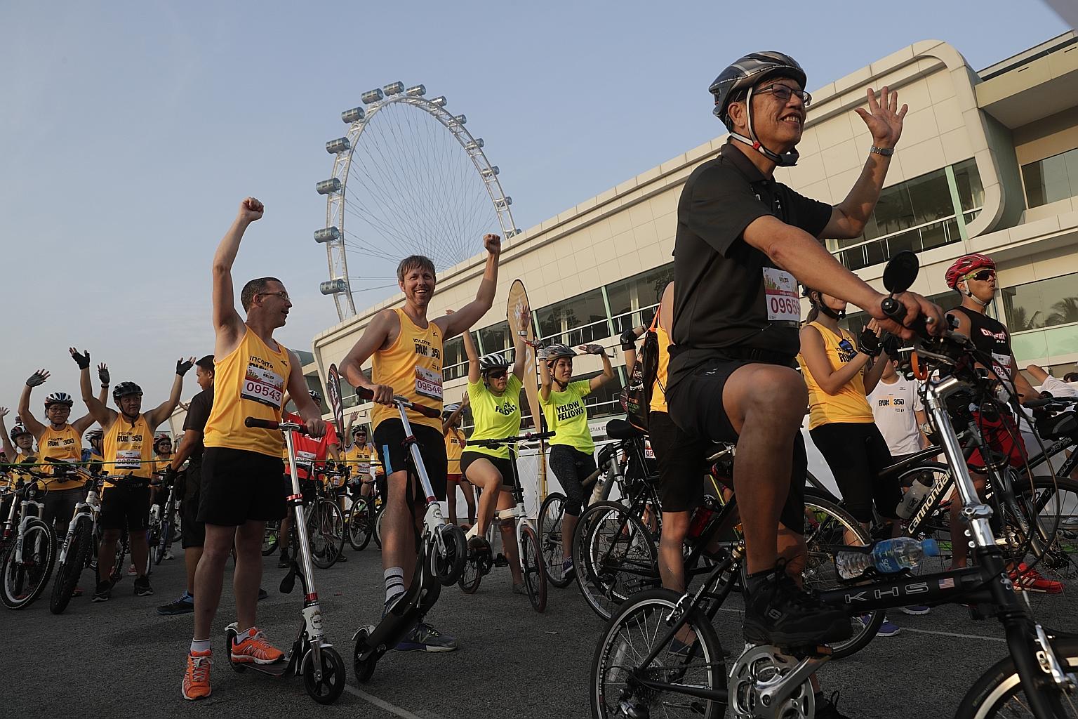 Hundreds, including humour columnist Neil Humphreys (fourth from left) and NTUC Club chief executive officer Yeo Khee Leng (right in black) gathered at the starting line at the F1 Pit Building yesterday morning for a different kind of race - instead 
