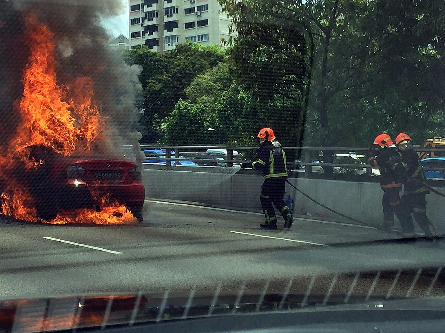 SCDF firefighters putting out the fire, which broke out on the CTE at about 1pm.