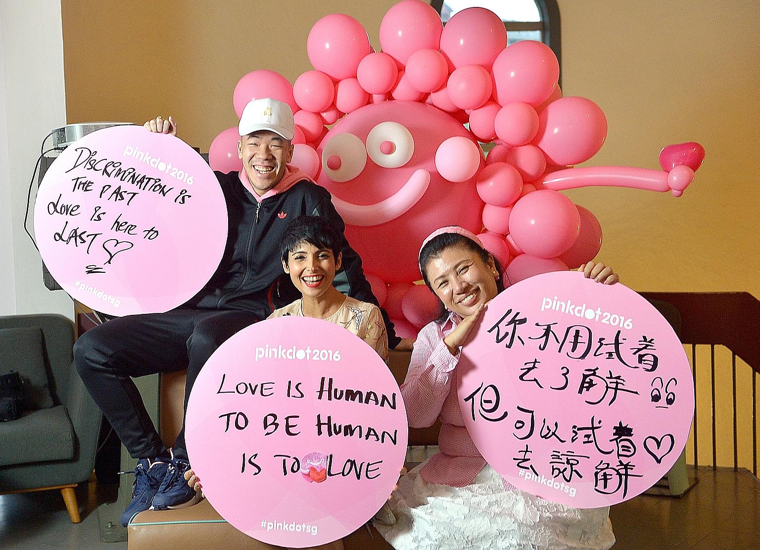 Pink Dot 2016 ambassadors (from left) rapper ShiGGa Shay, TV host Anita Kapoor and actress Liu Ling Ling with their self-written placards. Although some participants may write pro-LGBT messages that could alienate mainstream society, Pink Dot spokesm