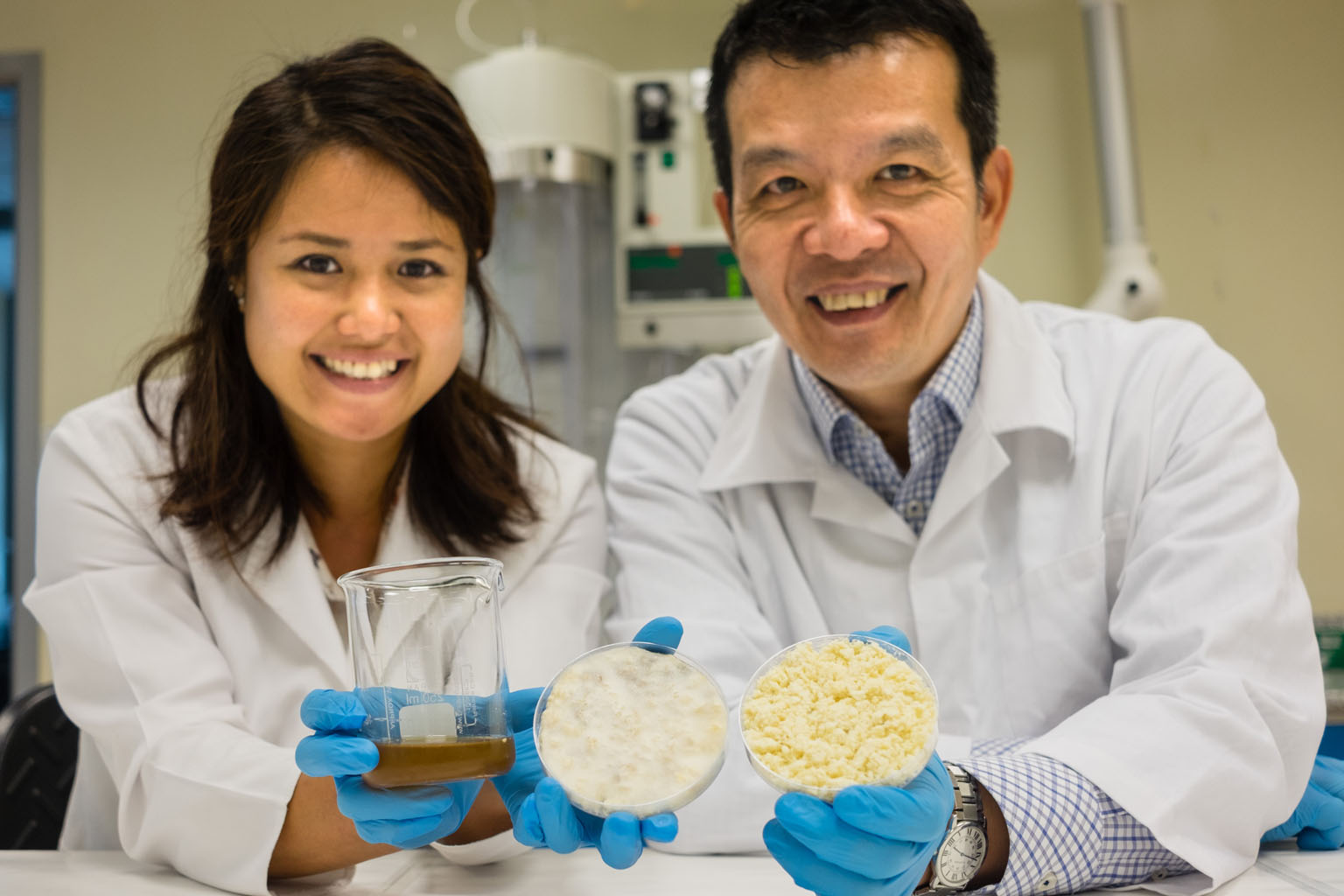 Dr Lee (left) and Prof Chen with the yeast growth medium they developed and samples of soya bean residue. A litre of their culture medium costs just $3.