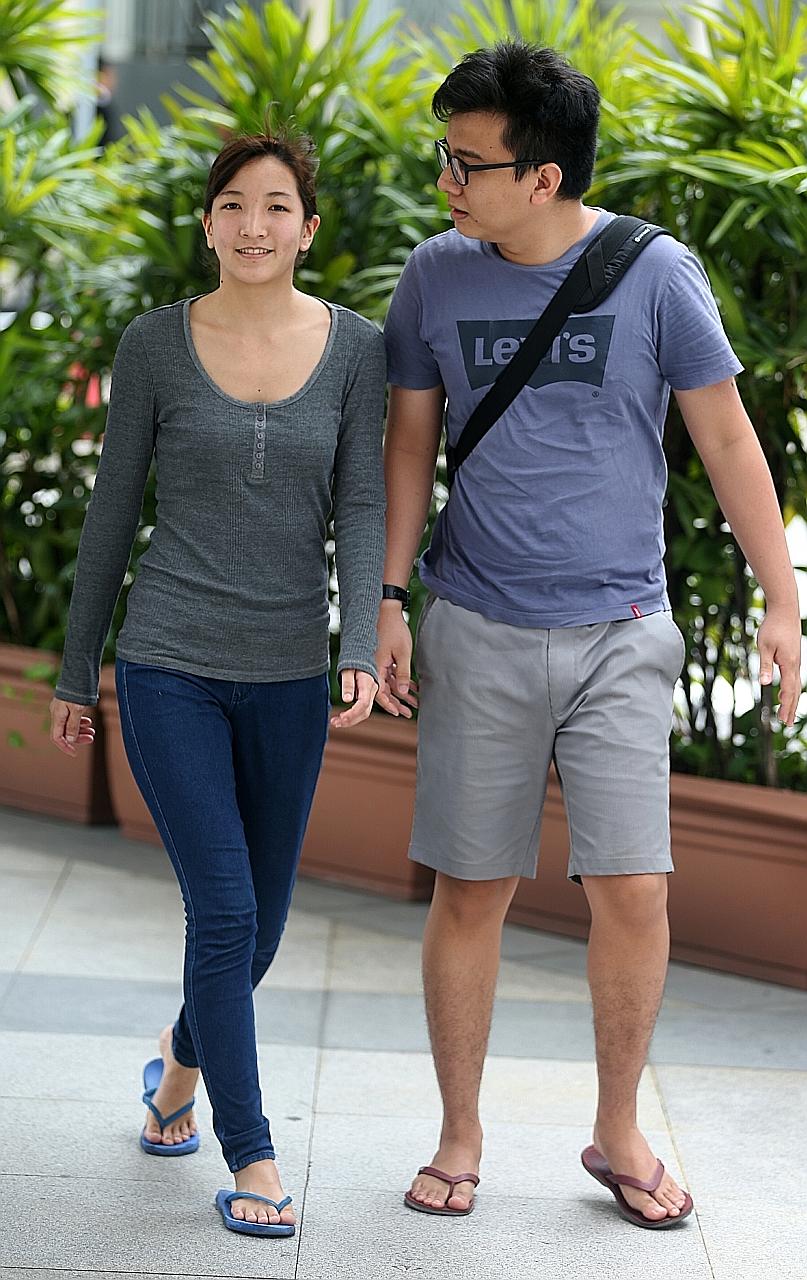 Takagi, who is 12 weeks pregnant, and her husband Yang at the State Courts yesterday. She began her 10-month term yesterday.