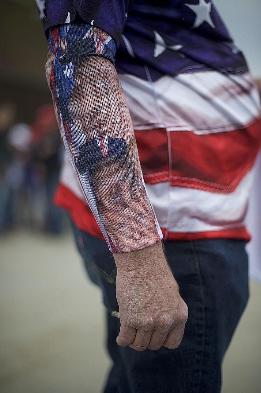 A campaign supporter wearing a Donald Trump-themed sock on his arm at a rally in Pennsylvania this week. Mr Trump has been firing up supporters with claims that party rules are rigged.