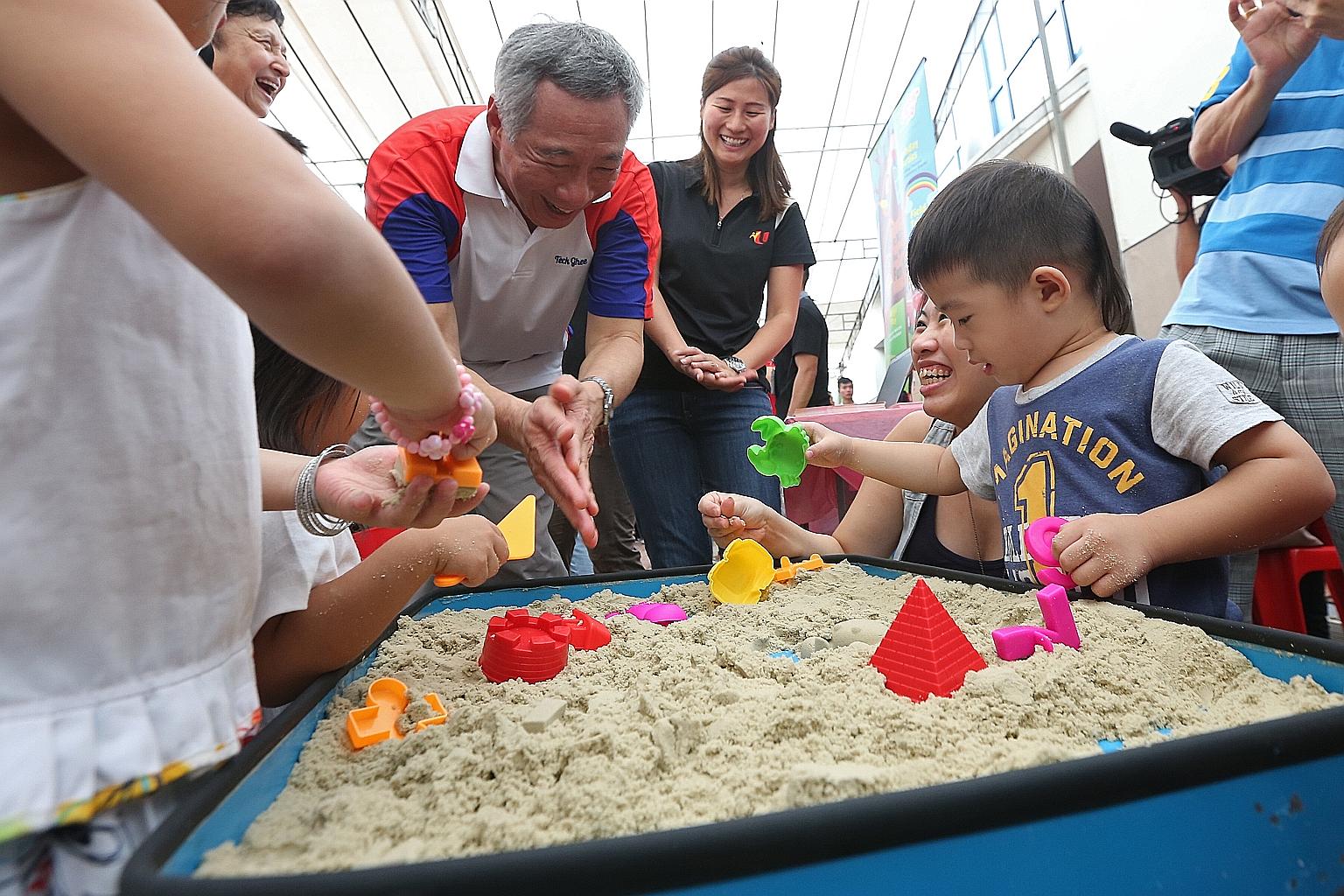 Mr Lee with young children at a sand box in Teck Ghee Community Club yesterday. The Prime Minister was happy to learn that a Healthy Baby contest held there attracted 145 baby contestants, almost double the number of participants last year.