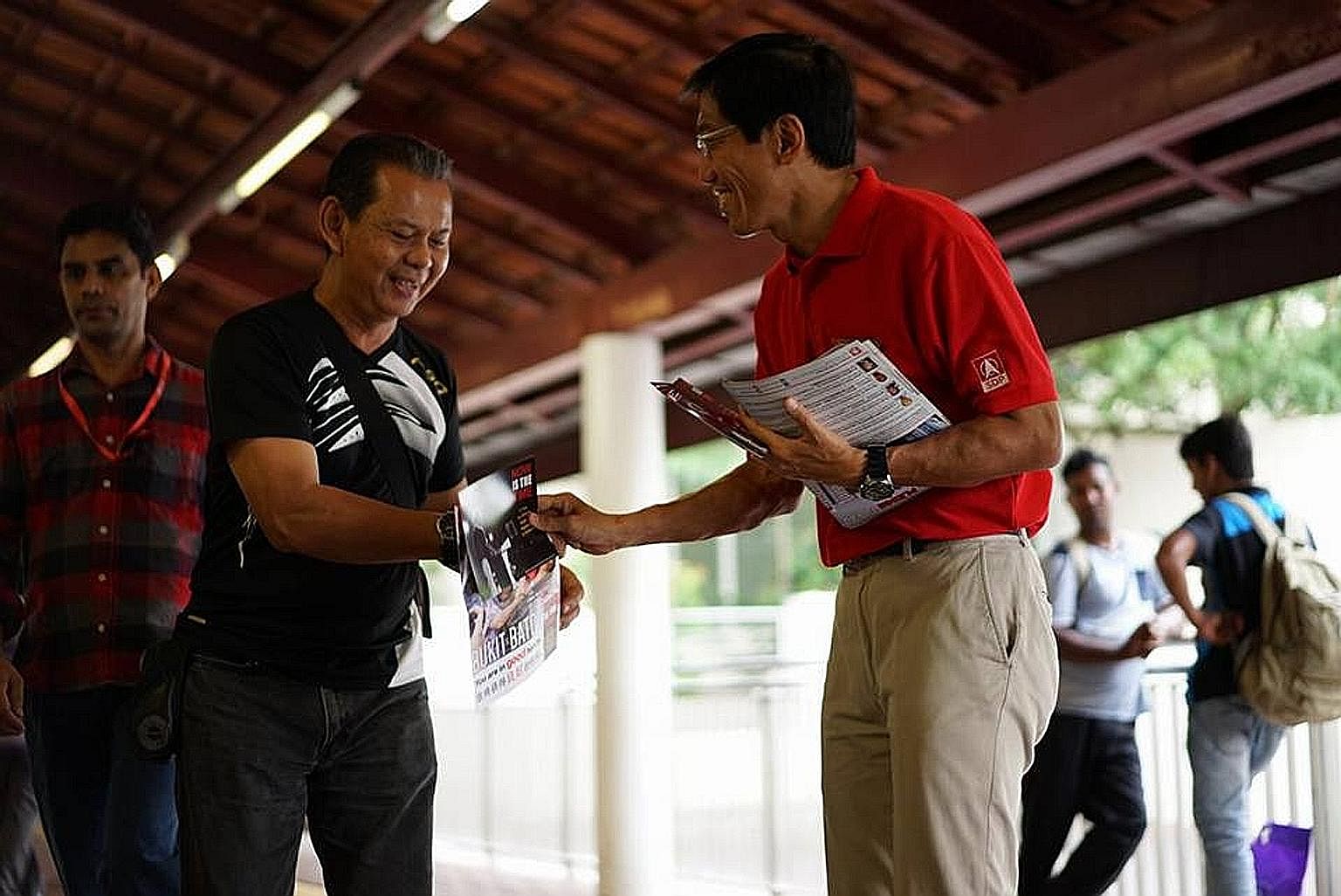 Dr Chee Soon Juan, SDP's candidate for the Bukit Batok by-election, greeting a resident near Bukit Batok MRT station. He spent the Nomination Day eve distributing fliers and greeting commuters at the station.